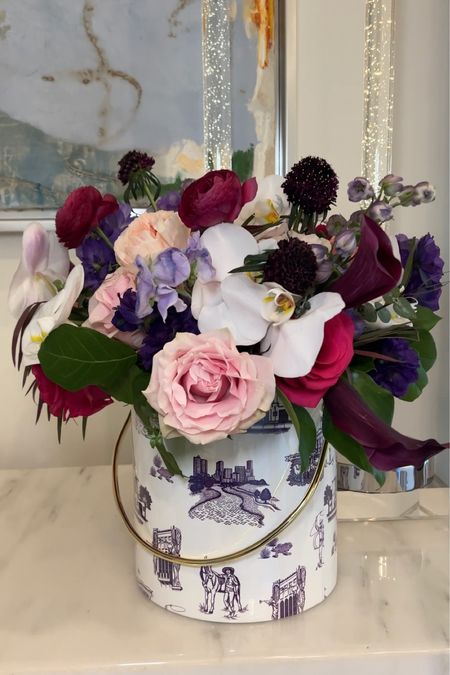 I love being creative and unexpected when entertaining or gifting. I placed this beautiful floral arrangement in this game-day inspired ice bucket. A fun touch to my pre-game gathering.💜🤍This is also fabulous as a hostess gift  

#LTKfindsunder100 #LTKstyletip #LTKhome