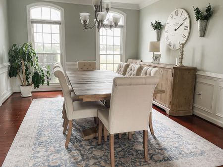 The dining room is finally finished! Trestle dining table, upholstery button tufting dining accent chair, large area rug, dining buffet, large wall clock, galvanized wall planters and eucalyptus decor, wood candlesticks, small lamp#LTKFind

#LTKhome