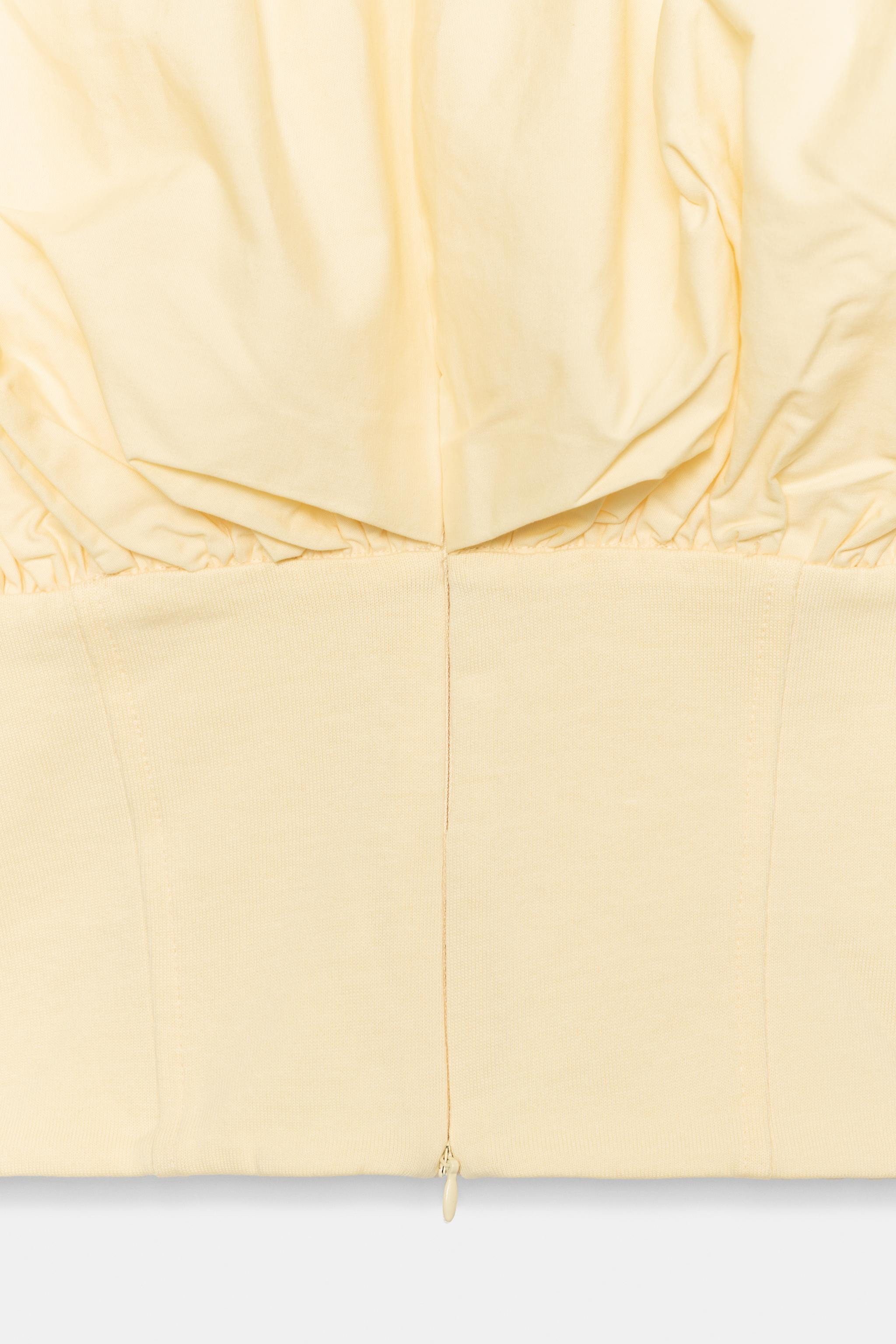 Sleeveless top crafted in a cotton-blend fabric. Featuring a round neckline, a straight hem, and ... | Zara US