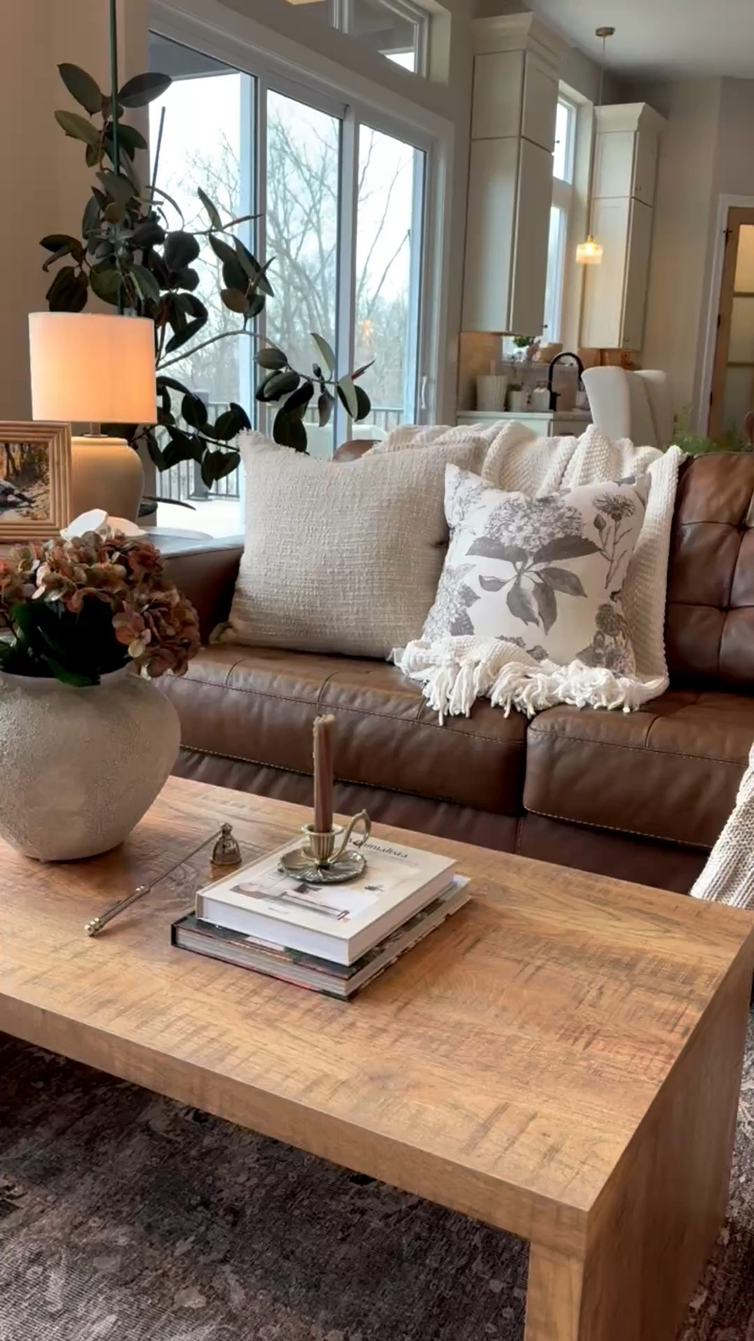 A touch spring coffee table styling with a brown leather couch  

#LTKHome