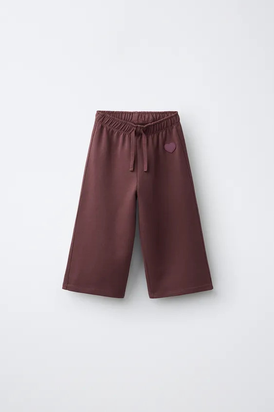 Wide leg plush pants with an elastic waistband and front drawstring detail. Features a rubberized... | Zara US