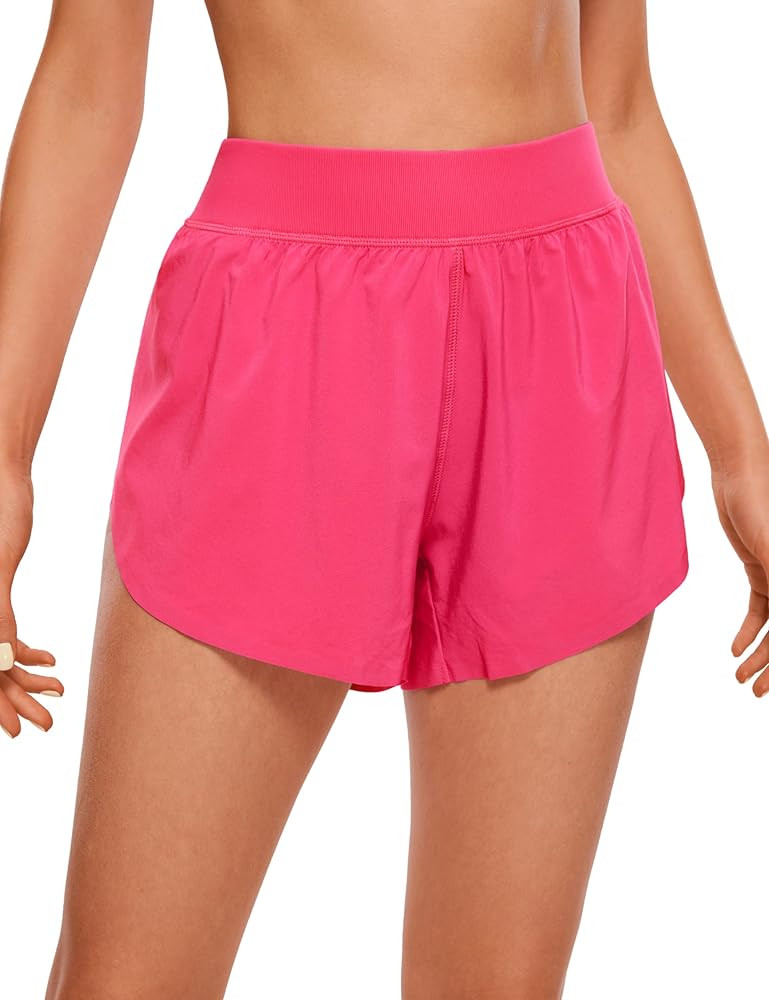 CRZ YOGA Mid Waisted Dolphin Athletic Shorts for Women 4" Lightweight High Split for Gym Workout ... | Amazon (US)