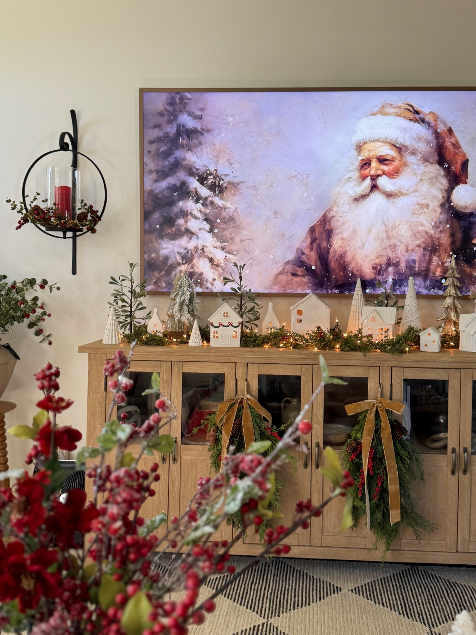 Pre-lit Christmas houses for village display at different price points. Table top Christmas trees. Narrow Christmas garland. Hanging wall sconces with candle and candle ring. Solid wood TV buffet. Faux red Christmas berry stems  and greenery. Samsung The Frame Samsung TV and frame. Christmas swags. 

#LTKHome #LTKSaleAlert #LTKSeasonal