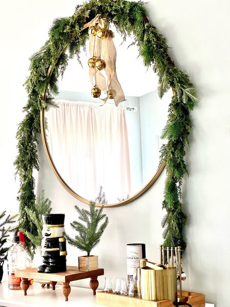 Dining room buffet mirror styled for the holidays. The garland keeps selling out but I have added other look alikes. #walmarthome #targethome #christmasdecor #christmashomedecor #garland #goldbells 

#LTKHoliday #LTKhome #LTKSeasonal
