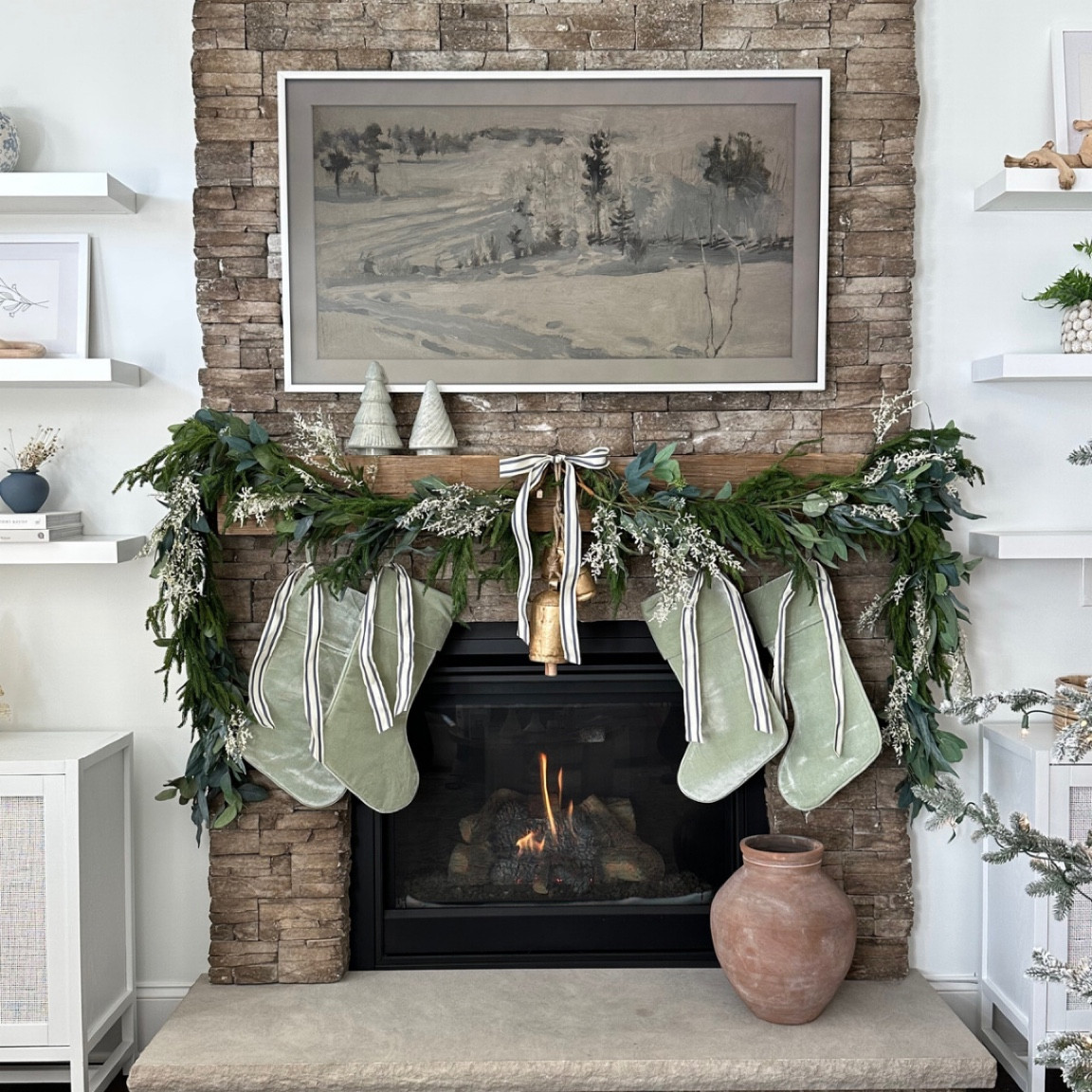 Fireplace mantle decor. Garland and stockings with ribbon and bells 

#LTKHoliday #LTKhome #LTKSeasonal