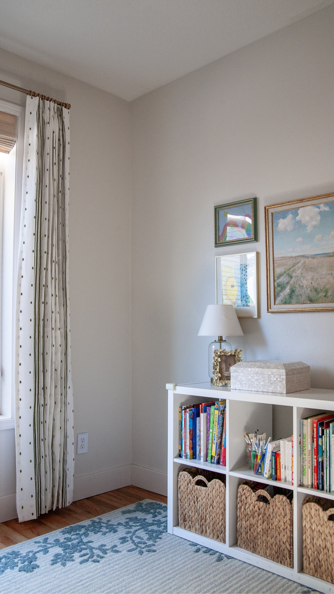 I am shocked at what we were able to do in this playroom! My friend and I have been making over her playroom with new rug and furniture, etc. We swapped out the boob light fixture, hung a gallery wall including some kid art… but the room was feeling bare until we hung the right window coverings. We swapped out the builder basic blinds with some bamboo Roman shades and added these really cool embroidered curtains from Twopages. (Don't forget the little metal hooks that go on the ends of pleated curtains.)

Super cool feature of the Roman shades: this window is so tall we definitely needed motorized in here because it's hard to reach! The remote control makes them go up and down easily.

Curtains: I love to add lining and always do pleats for extra fullness. My Twopages code SUZANNAHSTANLEY gets you 23% off your order of any of their shades, curtains, and more.

We were able to fit books, art supplies, a cozy reading corner, some lamps, and more. I'm so happy we were able to turn this room into something beautiful and super functional for their family ❤️

@twopagescurtains #twopageshome

#LTKHome