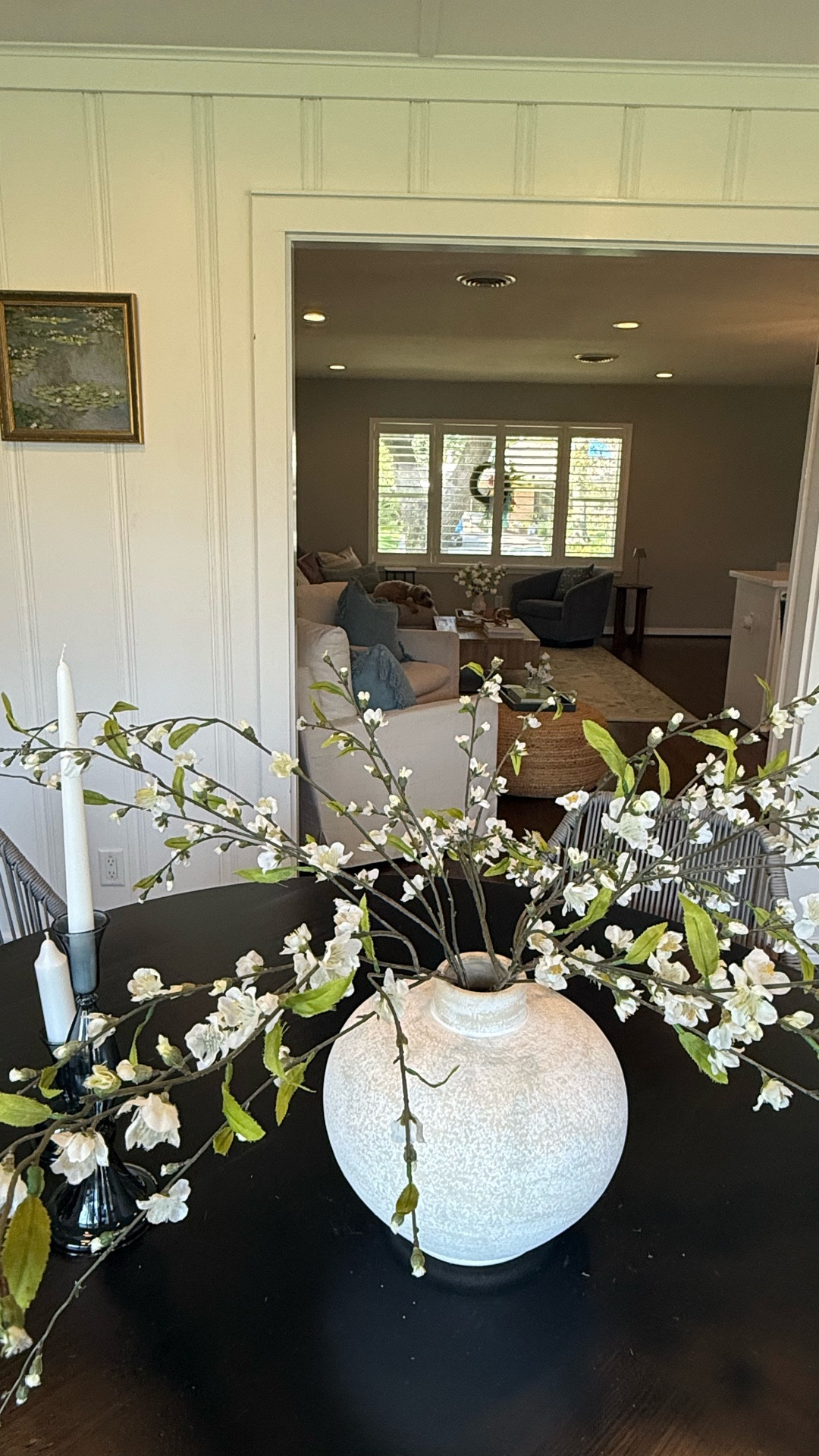 Our dining room sunroom is inspired by cozy Sunday suppers 🍝🍷. I styled this space with a round black dining table, neutral rope dining chairs with wood legs, and a blue and ivory vintage-inspired rug for a warm, timeless look. The centerpiece is a white textured ceramic vase filled with faux spring blossom stems, paired with glass taper candlestick holders and white taper candles for a soft, inviting glow.

Also linking similar buffet sideboards, wine racks, and gold frame Monet wall art prints to complete the look. Style keywords: modern farmhouse, California coastal, transitional dining, and cozy sunroom vibes. #LTKhome #LTKdiningroom #DiningRoomDecor #SunroomStyle #RoundDiningTable #DiningRoomInspo #NeutralHomeDecor #FauxFlorals #ModernFarmhouseDecor #CaliforniaCoastal Sunroom Dining Room Decor – Round Black Table, Rope Dining Chairs, Textured Vase & Faux Branch Centerpiece

#LTKFindsUnder50 #LTKHome