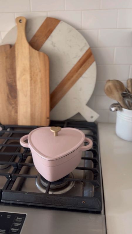 This pink heart shaped cast iron Dutch oven is back and such a great price!!! Also sharing my cutting / serving boards that I have displayed behind the stove  

#LTKhome #LTKfindsunder50