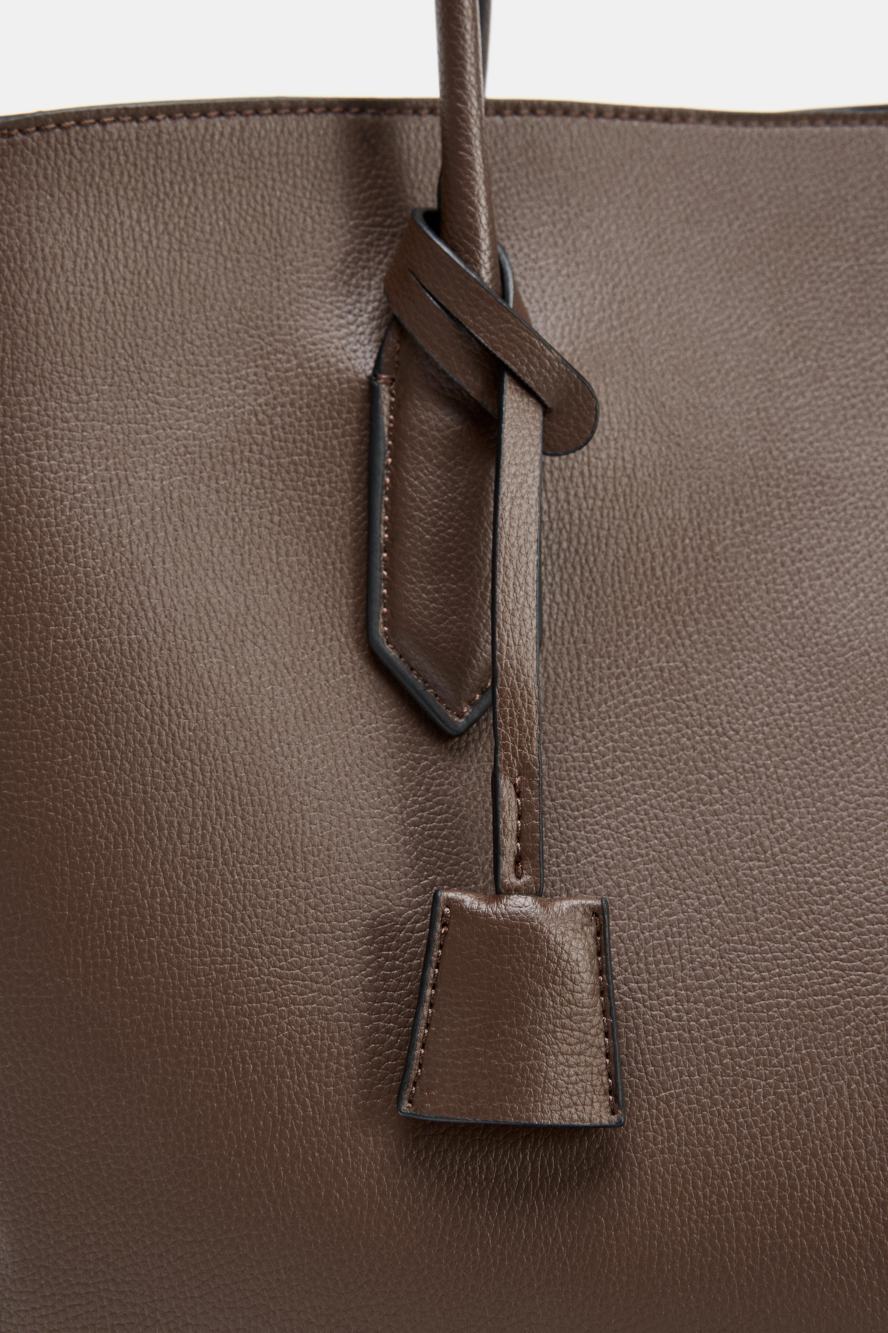 Leather shoulder bag. Metallic strap with details. Topstitching detail on the body. Multiple pock... | Zara US