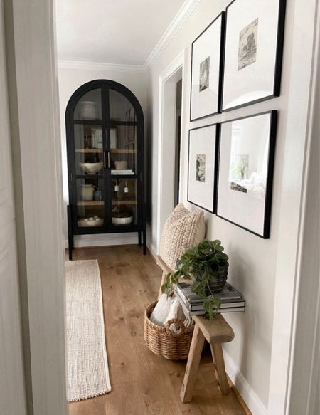 Gallery wall inspiration, frames, wall art, accent wall, arched cabinet, curio cabinet, wooden bench, neutral decor, spring decor, faux plant, area rug, jute rug, black cabinet, arched cabinet 

#LTKHome #LTKStyleTip