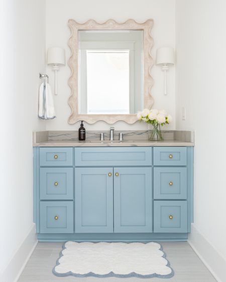 Our bathroom decorated for spring! We love the gold knobs on our blue cabinets, and I added these faux peonies, scalloped bath mat, and scalloped hand towel for spring! Also linking our white sconces and scalloped wood mirror. See our full spring home tour here: https://lifeonvirginiastreet.com/2024-spring-home-tour/.
.
#ltkhome #ltkseasonal #ltksalealert #ltkstyletip #ltkfindsunder50 #ltkfindsunder100 coastal decor, spring decorating ideas#LTKsalealert #LTKhome

#LTKSeasonal #LTKHome #LTKSaleAlert