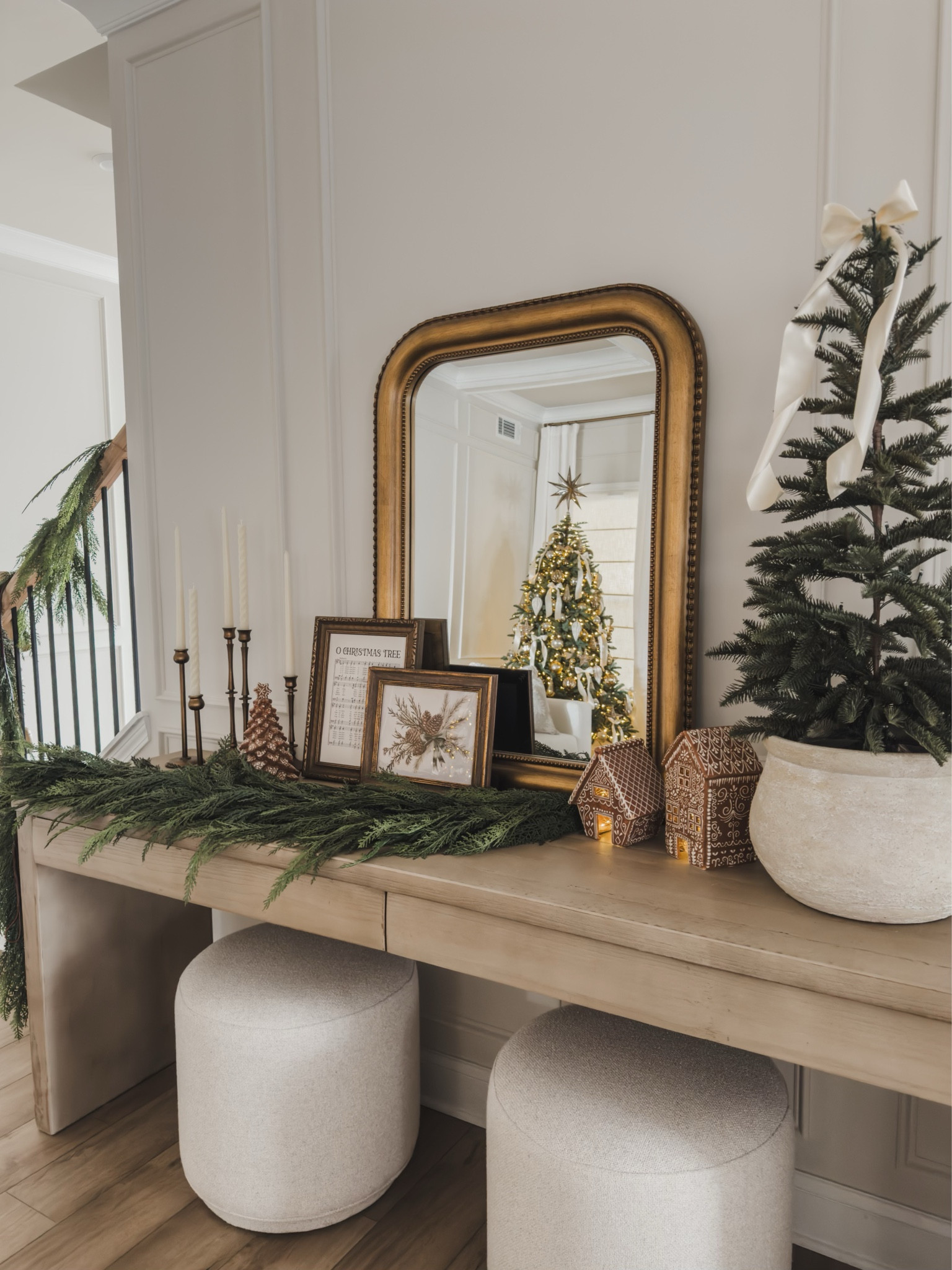 Christmas console styling featuring Pottery Barn! Draping cedar garland combined with an ornate gold mirror and festive details 

Home views, neutral home style, console styling, Pottery Barn style, gold mirror, upholstered ottoman, faux tree, cozy Christmas, candle holder, tapered candle, gingerbread detail, gold frame, neutral Christmas vibes, Etsy, found it on Amazon, shop the look!

#LTKHome #LTKSeasonal #LTKHoliday