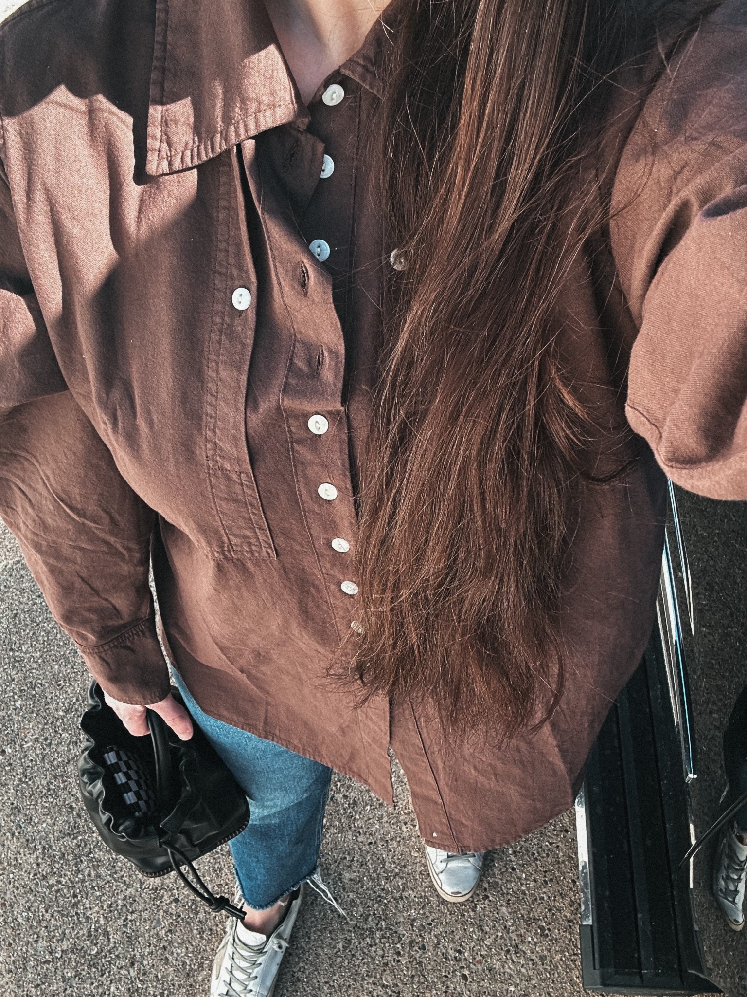 Brown button up, jeans, sneakers and a cute bucket bag  

#LTKStyleTip