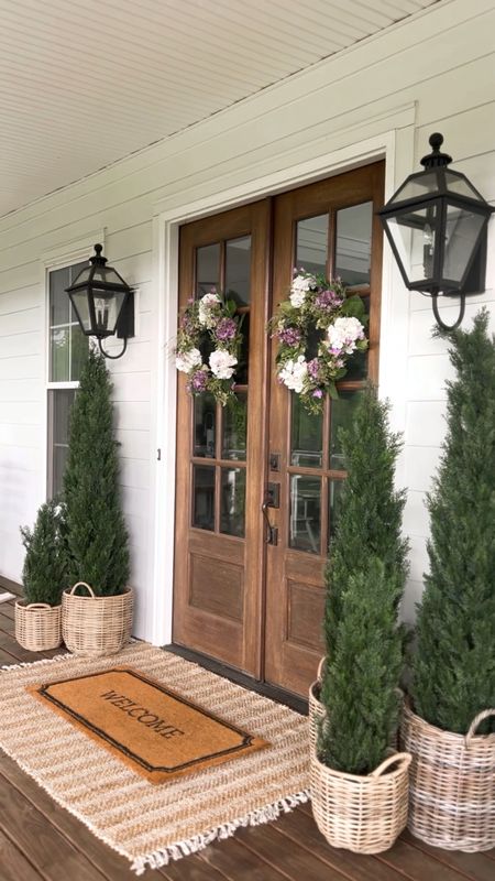 Front porch door spring and summer decor outdoor lantern wall sconce lighting light fixtures double layer doormat and jute scatter rug resin rattan baskets oversized large white planter spiral boxwood topiary trees faux artificial plants and flowers geranium hydrangea wreaths southern farmhouse modern design Amazon target nearly natural Etsy Cedar trees hydrangea wreath target deals

#LTKFind #LTKhome #LTKSeasonal