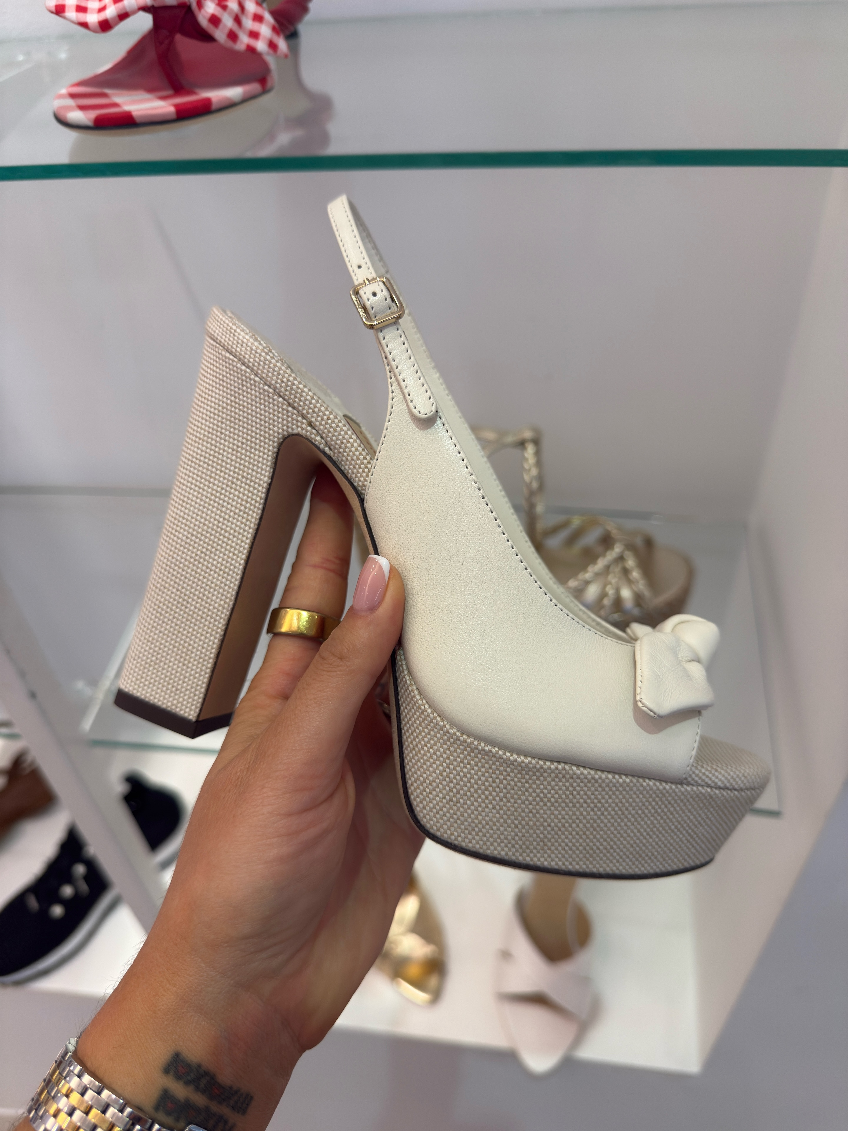 This is the shoe you buy when you want people to ask where you got your shoes.
The Riviera Ziva is a platform slingback with a chunky canvas-wrapped block heel, a leather upper, and a little bow detail at the peep toe that somehow makes the whole thing feel more intentional, not more precious. The cream and linen canvas combination is fresh without trying too hard — it reads summer wedding, birthday dinner, or any occasion where you want height without the instability of a stiletto.
The platform means that despite the 120mm heel, the actual pitch your foot is at is much more manageable than the height suggests. Block heel, platform base — this is a shoe you can actually be in for a few hours.

At $1,150 this is an event shoe with a strong visual return on investment. Style it with a linen wide-leg suit, a silk slip midi, or an all-cream look and let the texture mix in the shoe do the work. #shoes 

 