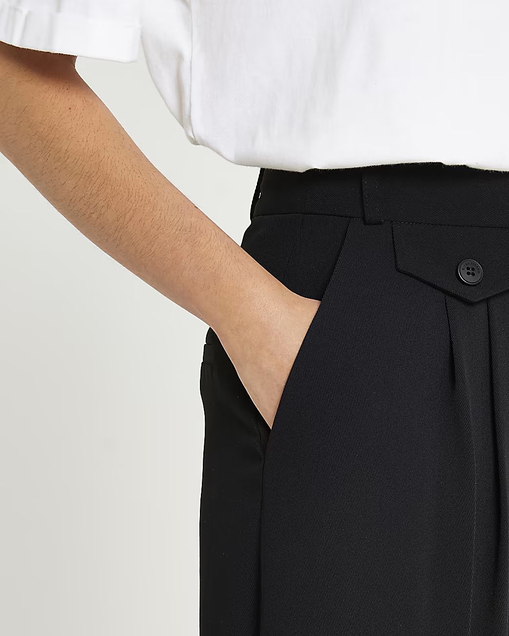 Black pleated tapered trousers | River Island (UK & IE)