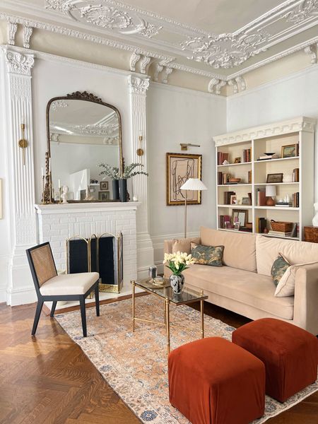 Living room furniture & decor- sofa, ottoman, rug, coffee table, mirror, sconce, vase, floor lamp 

#LTKFind #LTKhome #LTKstyletip