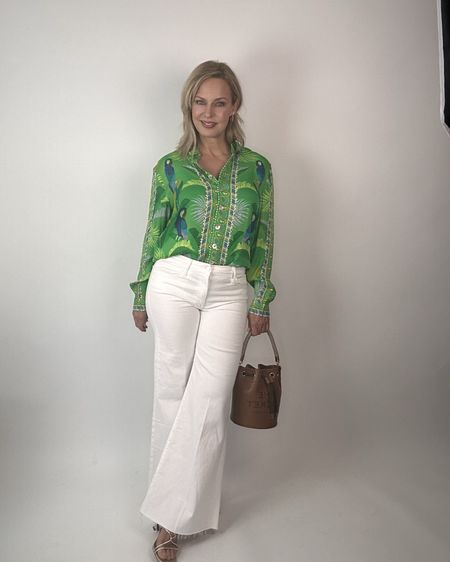 White frayed wide-flared jeans and a beautiful blouse make an easy spring outfit. The blouse is machine washable, true to size. I sized up in the jeans. They come in petite as well. 

#LTKVideo #LTKover40 #LTKitbag