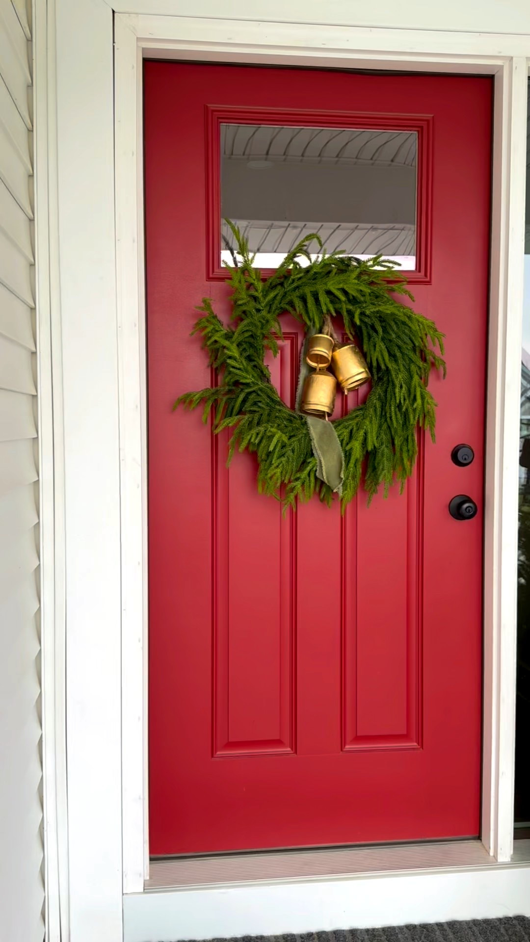 Proof that your Christmas door doesn’t need to be complicated. Don’t mind the saw dust 🫣 (we are activity working on a project). 
#wreath 
#christmas #frontdoor #holidays #christmasdecor #bells #ribbon 

#LTKHome #LTKHoliday