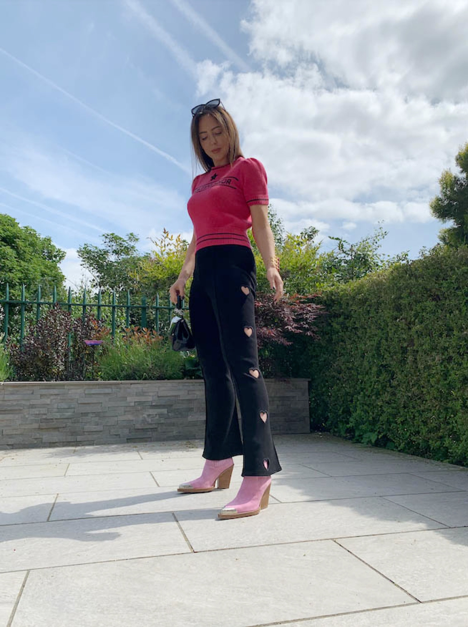 Pink cropped top, knit sweater jumper, black heart cut out leggings, pink ankle point toe boot heels, silver toe heels, black handbag 

#LTKeurope #LTKstyletip #LTKSeasonal