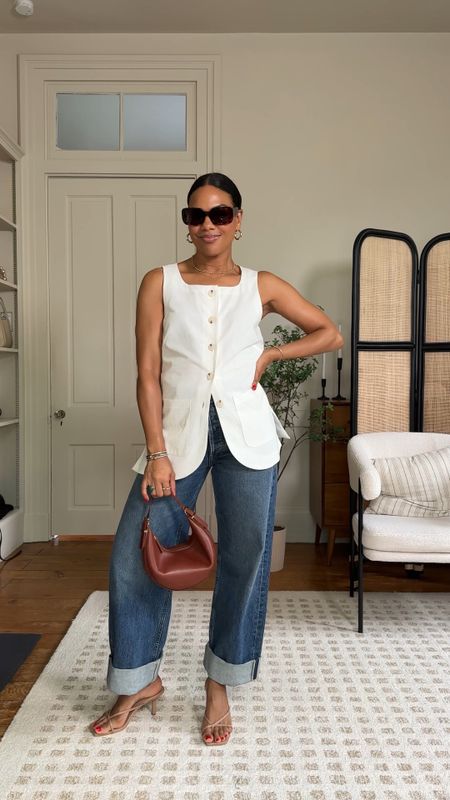Did someone say summer? This sleeveless button down vest is 🤌🏽. The perfect summer staple for a night out, running errands or just wanting to feel chic! Paired with a white tank, wide leg jean, strappy heel, and a colorful handbag. 

#LTKSeasonal #LTKOver40 #LTKStyleTip