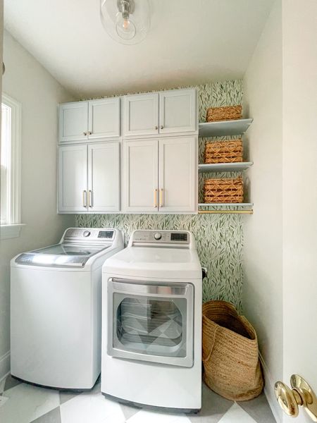 Tiny laundry room with big function. Love this green peel and stick wallpaper I got on sale. We painted these cabinets blue. Brass rod for hanging clothes. And some more things linked that you can’t see in this photo! 

#LTKfindsunder100 #LTKstyletip #LTKhome