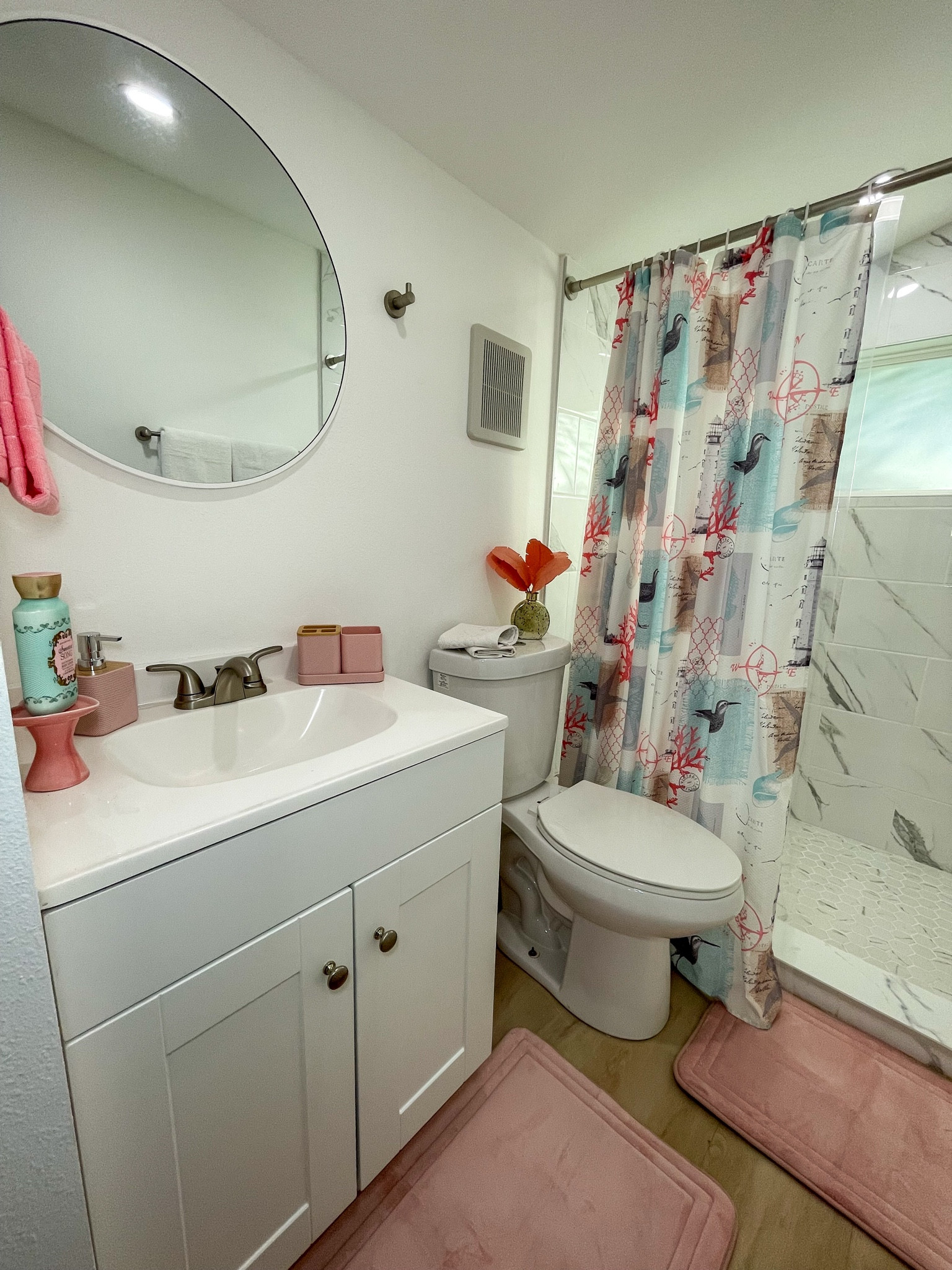 Bright modern bathroom with coastal-pink details.