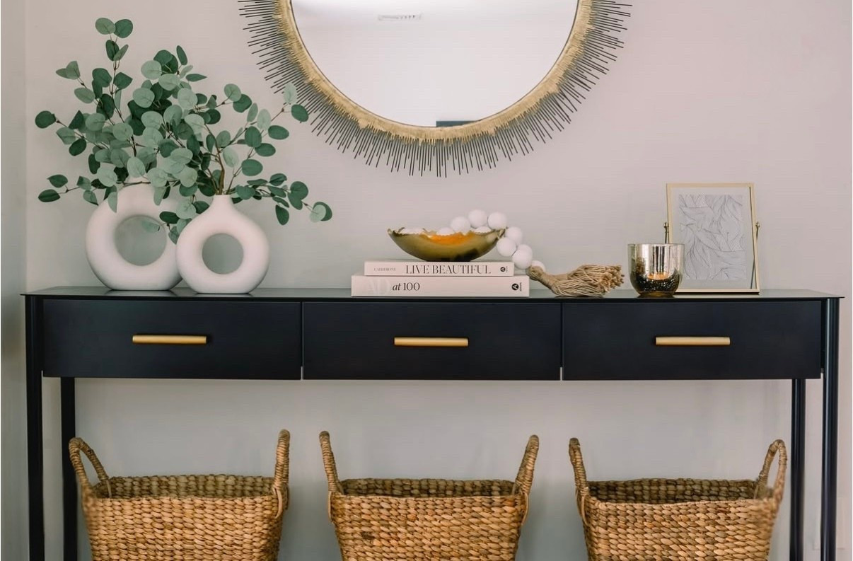 ✨ Console table goals ✨ Styled this black console with layered textures — woven baskets, sculptural vases, and a bold gold mirror to tie it all together. Proof that function can be just as beautiful as form. 

#LTKU #LTKStyleTip #LTKHome