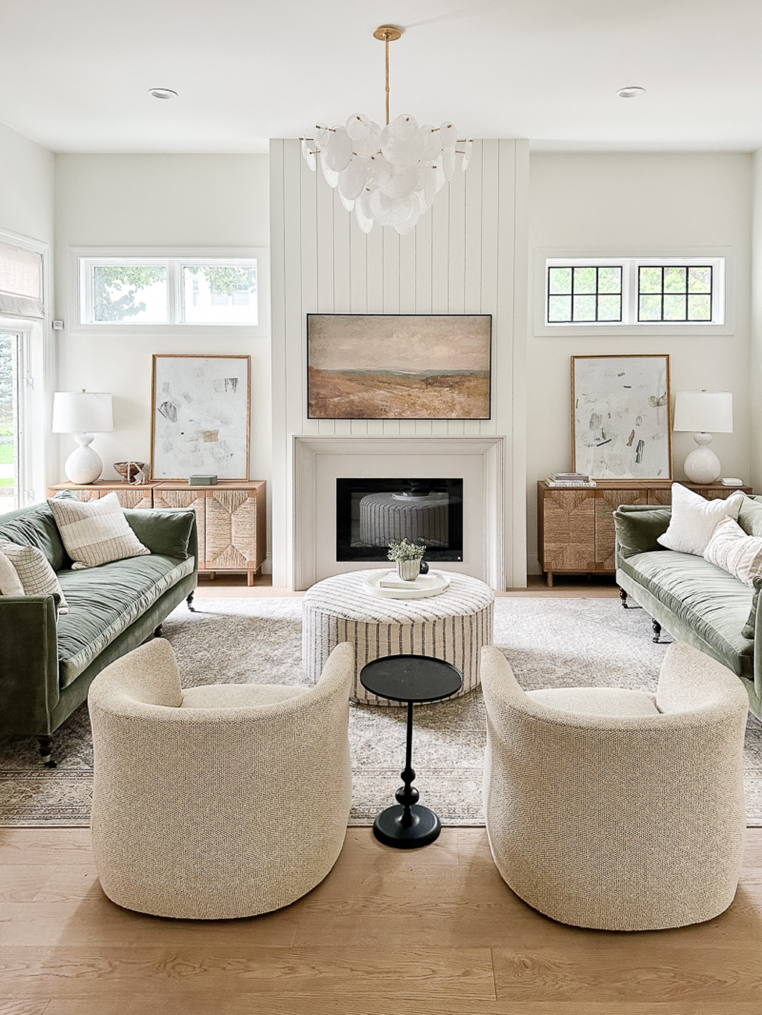 Shop my family room refresh! Living room, green sofas, area rug, swivel chairs, cozy living, artwork, Juniper, Amazon, side table, pillows, sideboard, Nathan James, chandelier, lamps

#LTKstyletip #LTKsalealert #LTKfamily