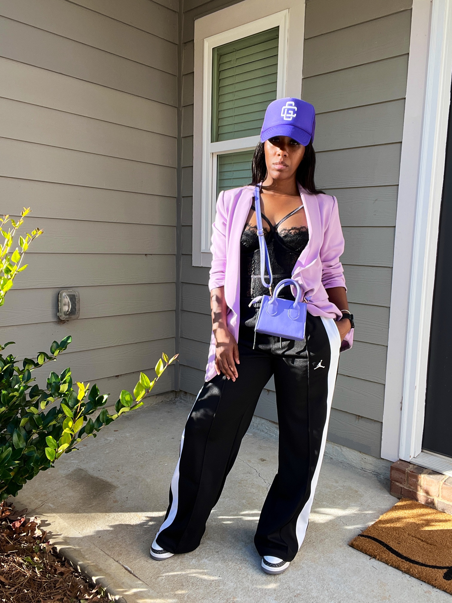 How to style knit track pants. I’m wearing a purple trucker hat, black lace bodysuit, purple blazer, purple crossbody purse, black and white track pants, and Jordan 3 dark iris sneakers

#LTKSeasonal #LTKStyleTip #LTKShoeCrush