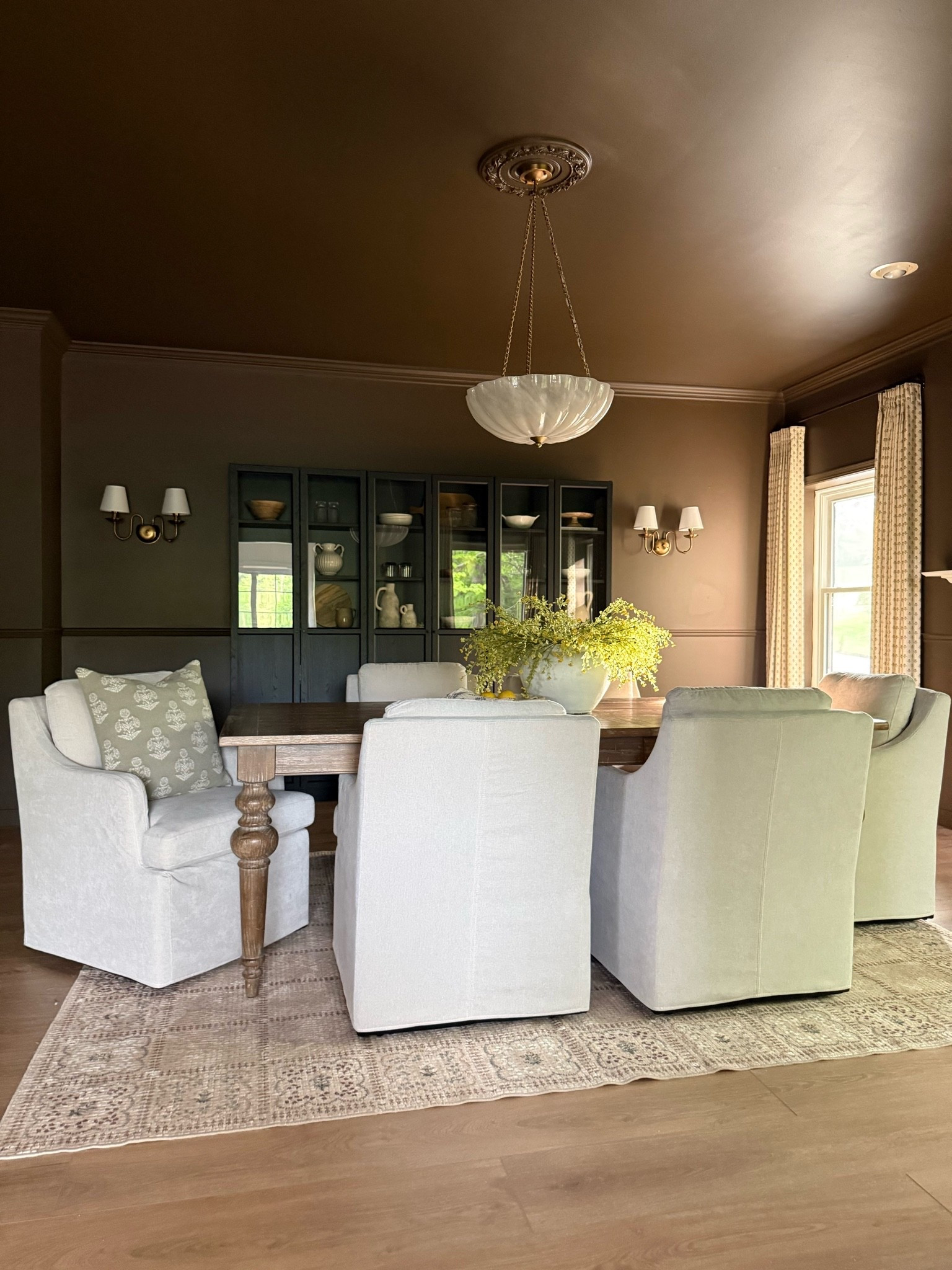 Moody dining room, dining room decor, dining room inspo, dining room design, dining room table, farmhouse table, dining room light, gold wall scones, gold chandelier, dining room chandelier, IKEA Billy Bookcases, linen dining chairs, dining room rug, dining curtains, floral curtains, large console table, console table decor, console table inspo, ceramic table lamp

#LTKSaleAlert #LTKHome