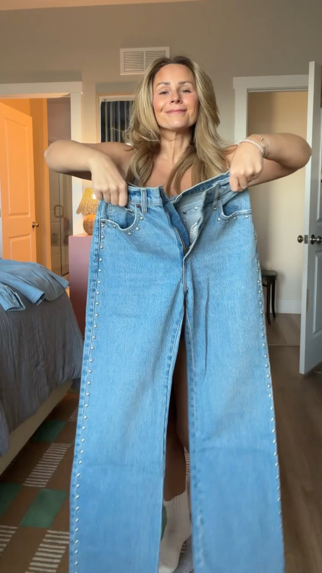 The difference is in the layers. Chambray, a cozy knit, and a wool coat take these studded jeans from casual to elevated — and yes, the Abercrombie denim is currently on sale. 🤍