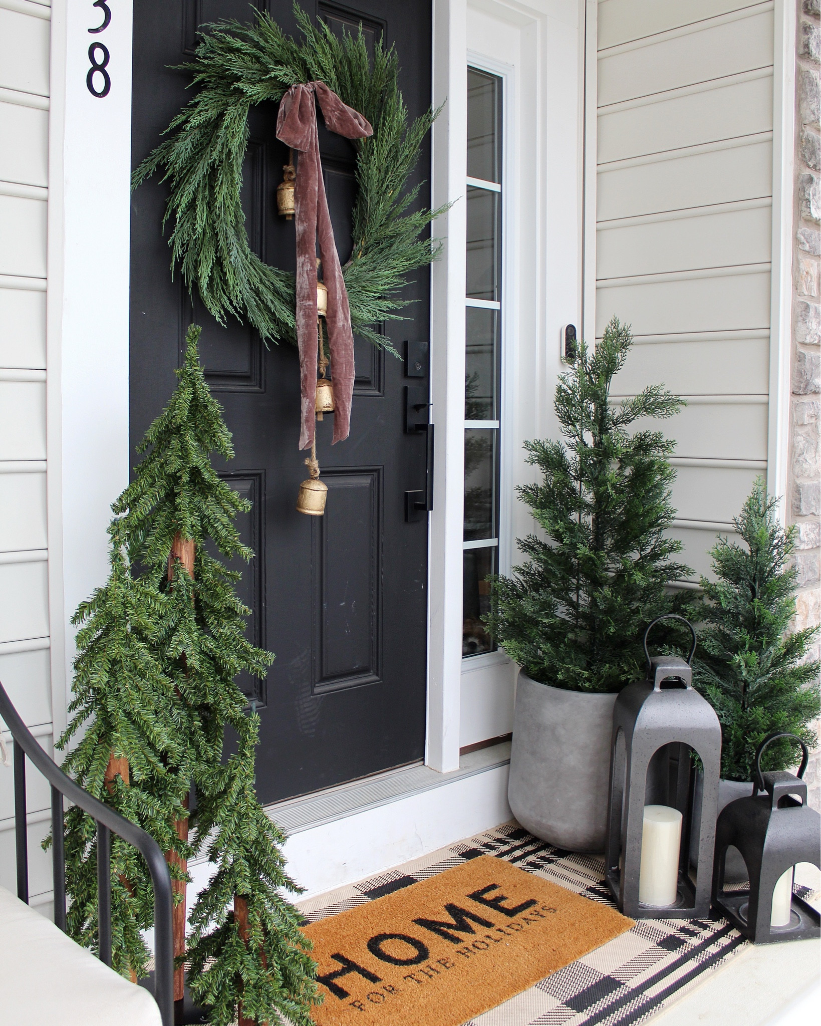 Holiday front porch decor, door mat, Christmas trees, cedar trees, bells, wreath, ribbon 

#LTKHoliday #LTKSeasonal #LTKHome