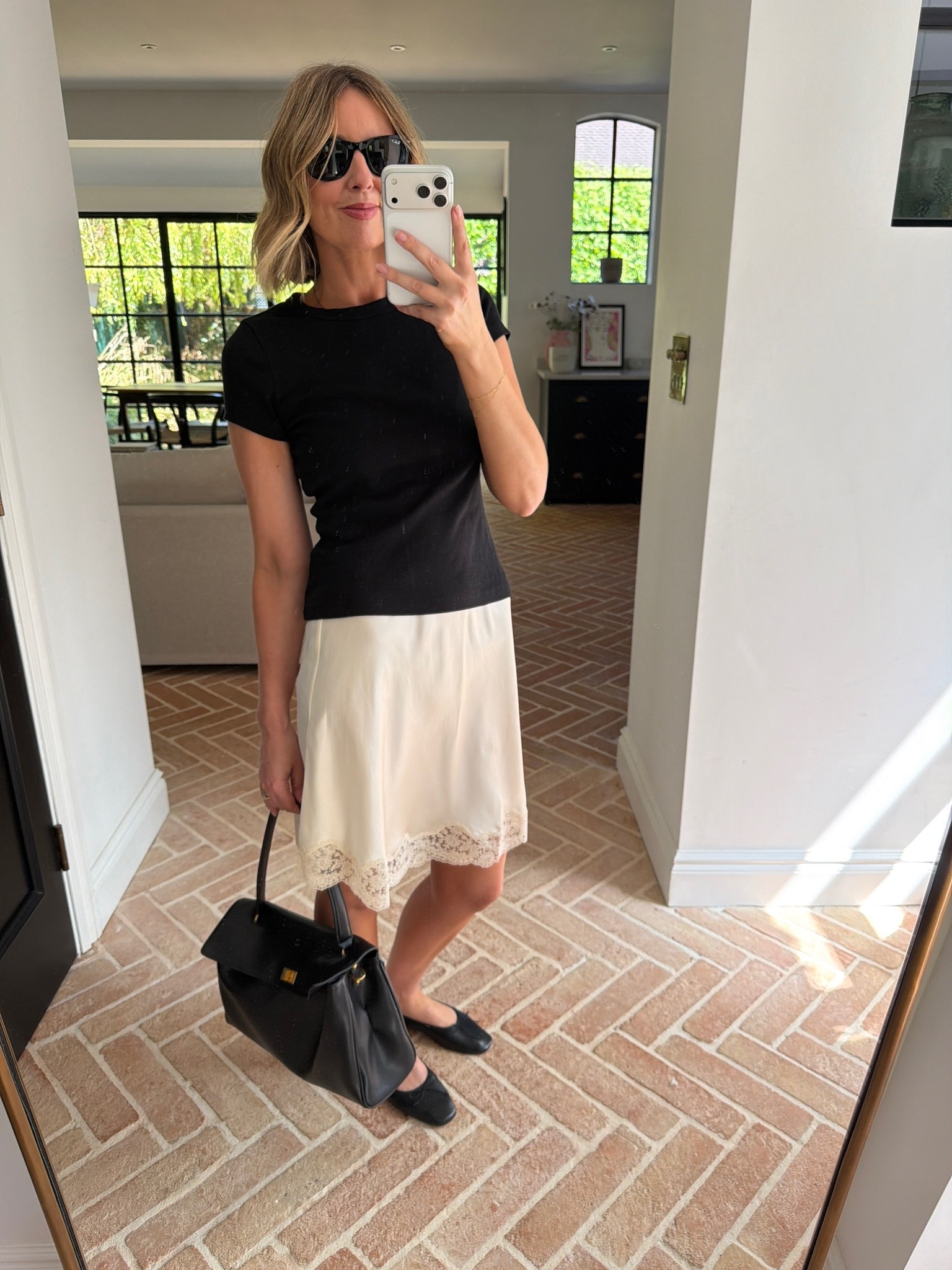 cream lace slip skirt, ivory satin skirt, lace hem midi skirt, slip skirt outfit, black fitted tee, black crew neck t-shirt, black and cream outfit, monochrome contrast, black structured bag, black top handle bag, black Kelly bag, gold hardware bag, black loafers, square toe loafers, black leather flats, black sunglasses, delicate gold bracelet, how to style a slip skirt, lace trim skirt outfit, t-shirt and skirt outfit, smart casual look, effortless chic, quiet luxury outfit, French girl style, minimalist fashion, classic outfit ideas, mirror selfie style, mum style, stylish mum outfit, over 40 style, ageless fashion

#LTKsummer #LTKdatenight #LTKuk