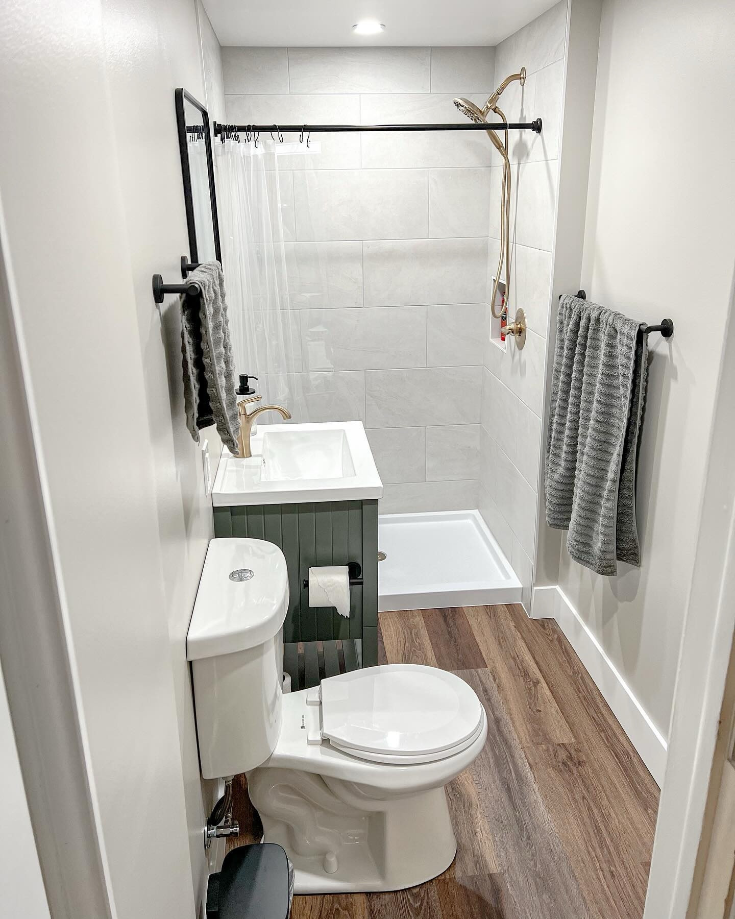 The bathroom remodel is finally complete! I gave this bathroom a facelift a few years ago, but the shower, vanity and most of the plumbing really needed to be replaced. I absolutely love how it turned out! We also added a heated floor, which is a game changer in a basement bathroom!
- - - - - - - - - - - - - - - - - - - - - -
Contractor: Brad Livezey
Floor: M & Z Carpets and Flooring
Shower Tile: @carpetandtilemart 
Niche tile: @loweshomeimprovement 
Vanity: @wayfair 
Mirror: @target 
Shower fixtures/Faucet: @deltafaucet 
Wall Color: @behrpaint Tranquil Gray
