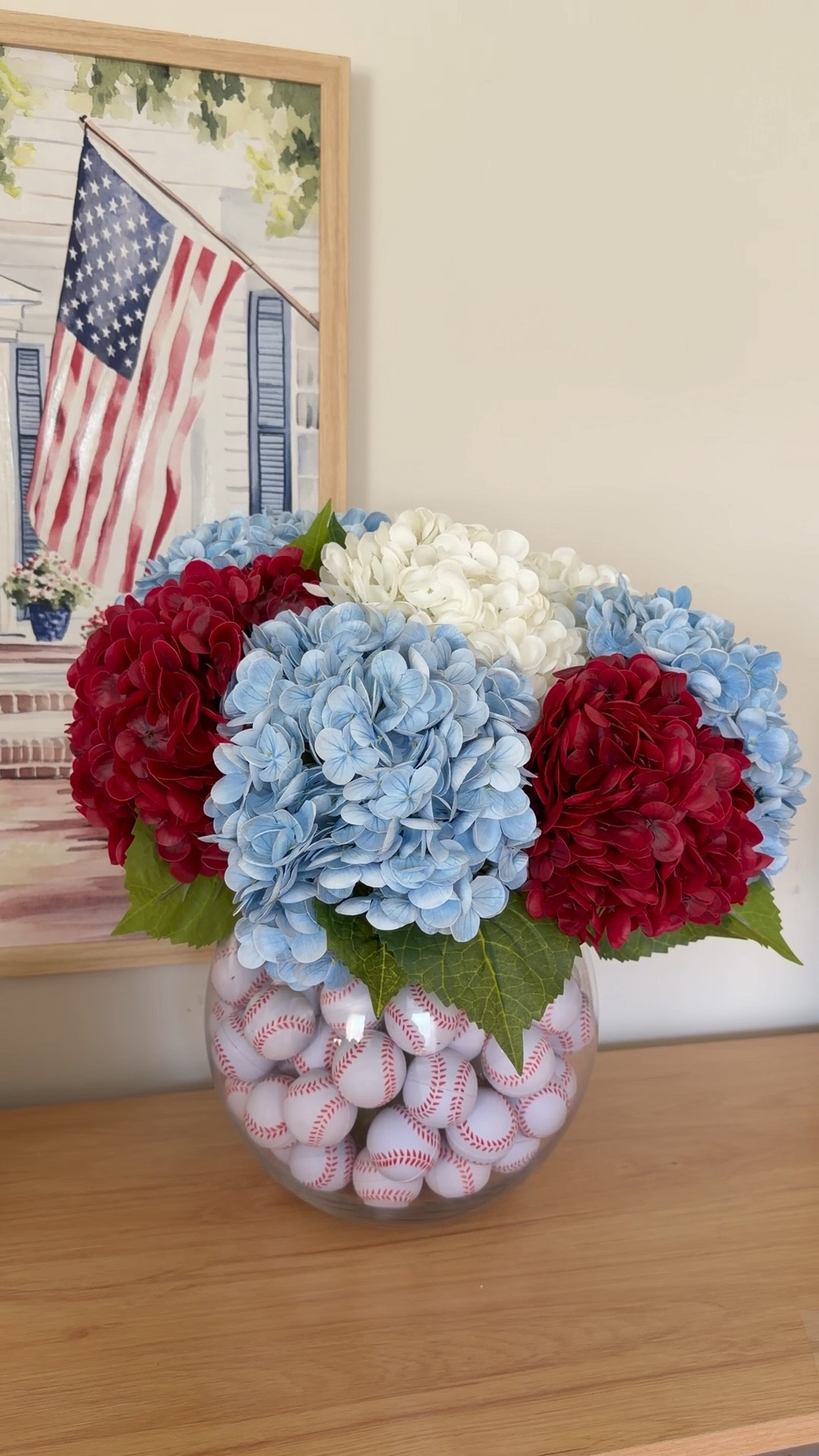 The red white and blue decor so far this year is SO cute and when I saw these mini baseballs I thought they’d be perfect for a patriotic centerpiece! They worked perfectly with these red white and blue hydrangeas (my favorites, they are SO realistic). I love displaying it with this gorgeous print from @Michaels (more soon from their new patriotic collection, it’s next level!!)

#LTKSeasonal #LTKHome