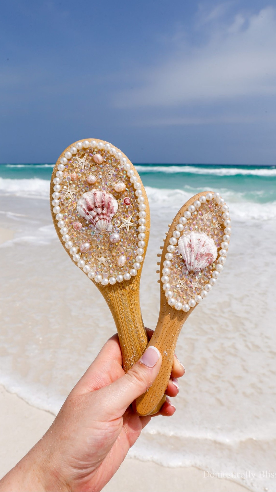 I really wanted to make a DIY Mermaid Hairbrush for Sabrina, as I’m working on creating a whole collection of mermaid accessories and crafts for her to play with and use in the future.
But then I couldn’t decide whether to make a small one for her to use now (because she loves to brush her hair with dinglehoppers) or a big one for when she is a little older.
So I decided it would be even more fun to make two, a mommy & me set of mermaid hairbrushes.
A small one for her now and a big one for her to use later (or for me to use until she is older).
I was going to completely cover them in pearls, but then I realized I didn’t have enough, so I opted for these craft crystals to fill in the space around the shells.
I wasn’t sure how it would look, but I’m in love with how it turned out.
The craft crystals kind of look like the bubbles and foam from waves crashing against the shore.
Plus, they sparkle beautifully in the sunlight!
When I handed it to her after her nap (oh yes, Rog & little Rog were up in the condo building LEGOs while Sabrina took a nap, and I decorated these hairbrushes on the beach), she immediately started brushing her hair.
And then she tried to pull the pieces off, because she is one, and that’s the stage we are in.
So I decided to tuck it away with the other shell crafts I’ve made over the last few years, so I can gift them all to her in the years to come.


See details: https://domesticallyblissful.com/diy-mermaid-hairbrush/

#LTKmomlife #LTKKids #LTKBeauty