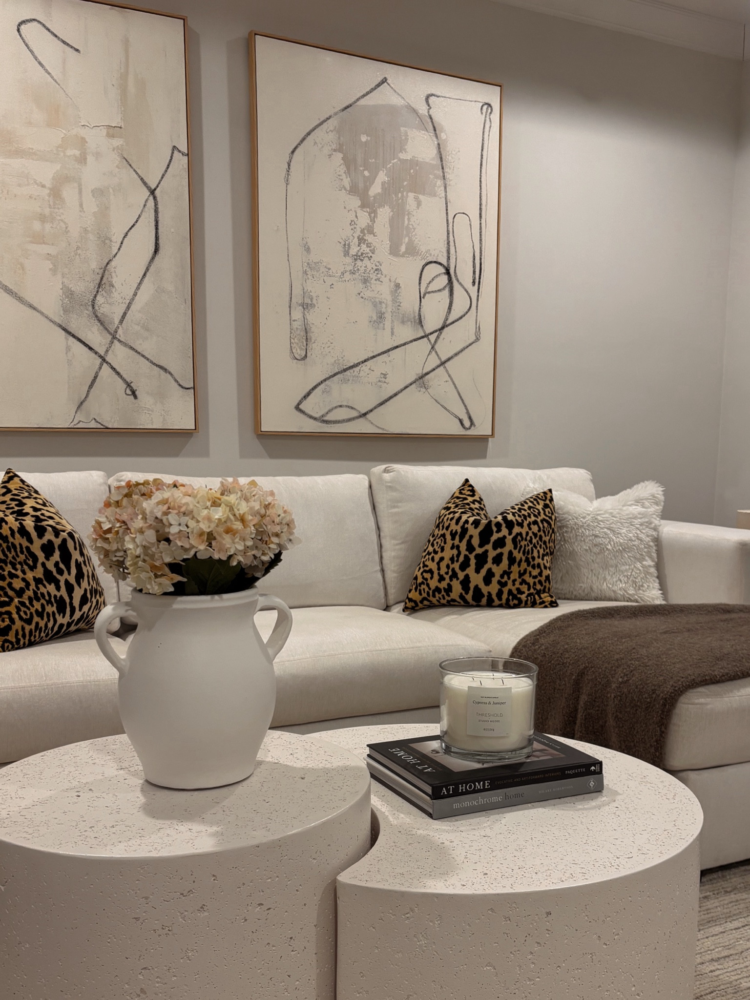 Neutral living room decor / leopard pillows / neutral abstract art / nesting coffee tables 

#LTKFindsUnder100 #LTKHome #LTKStyleTip