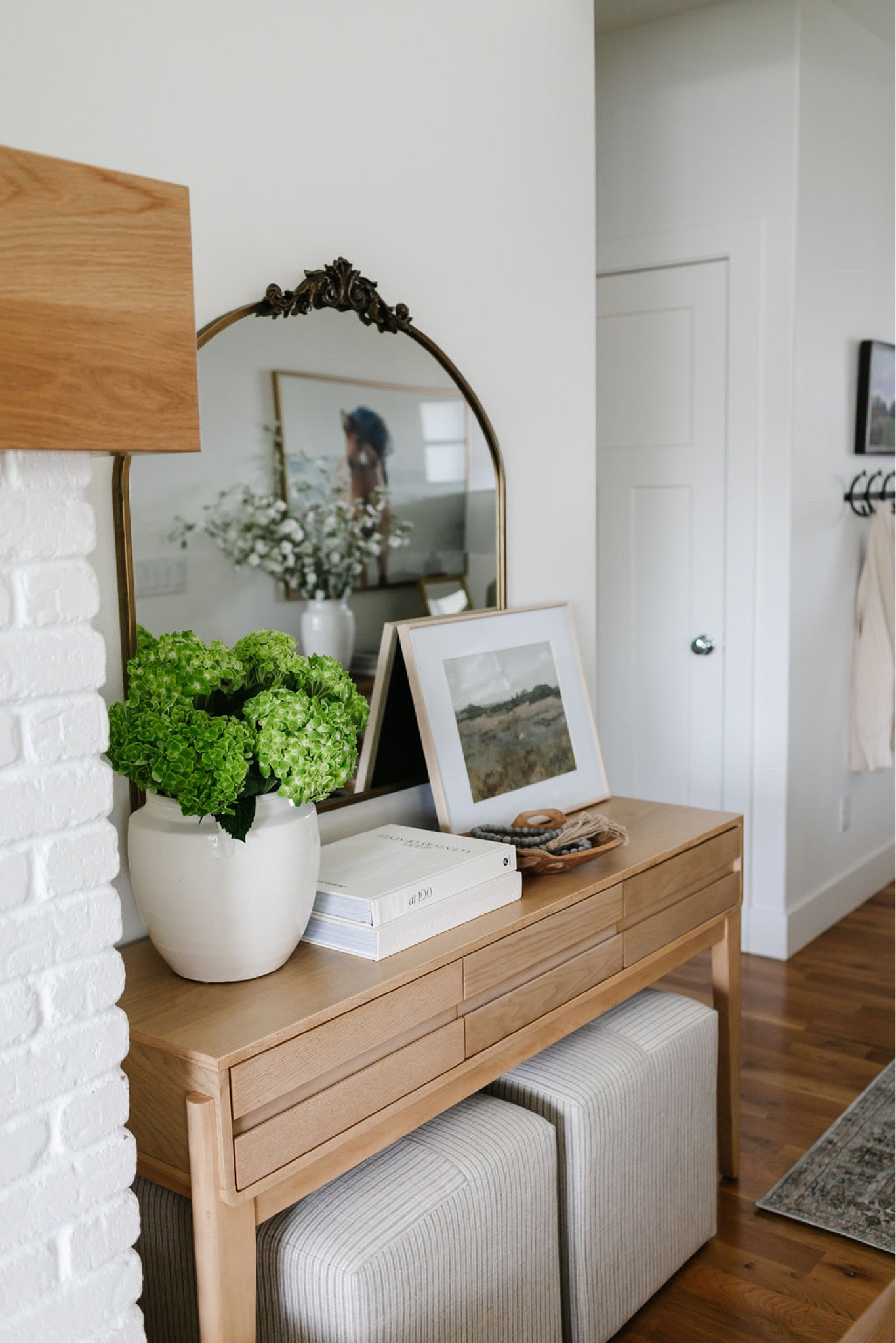 A console table that is perfect for summer with fresh or faux flowers, artwork, a pretty mirror above it and upholstered square ottomans for extra seating below  

#LTKSeasonal #LTKhome #LTKFind