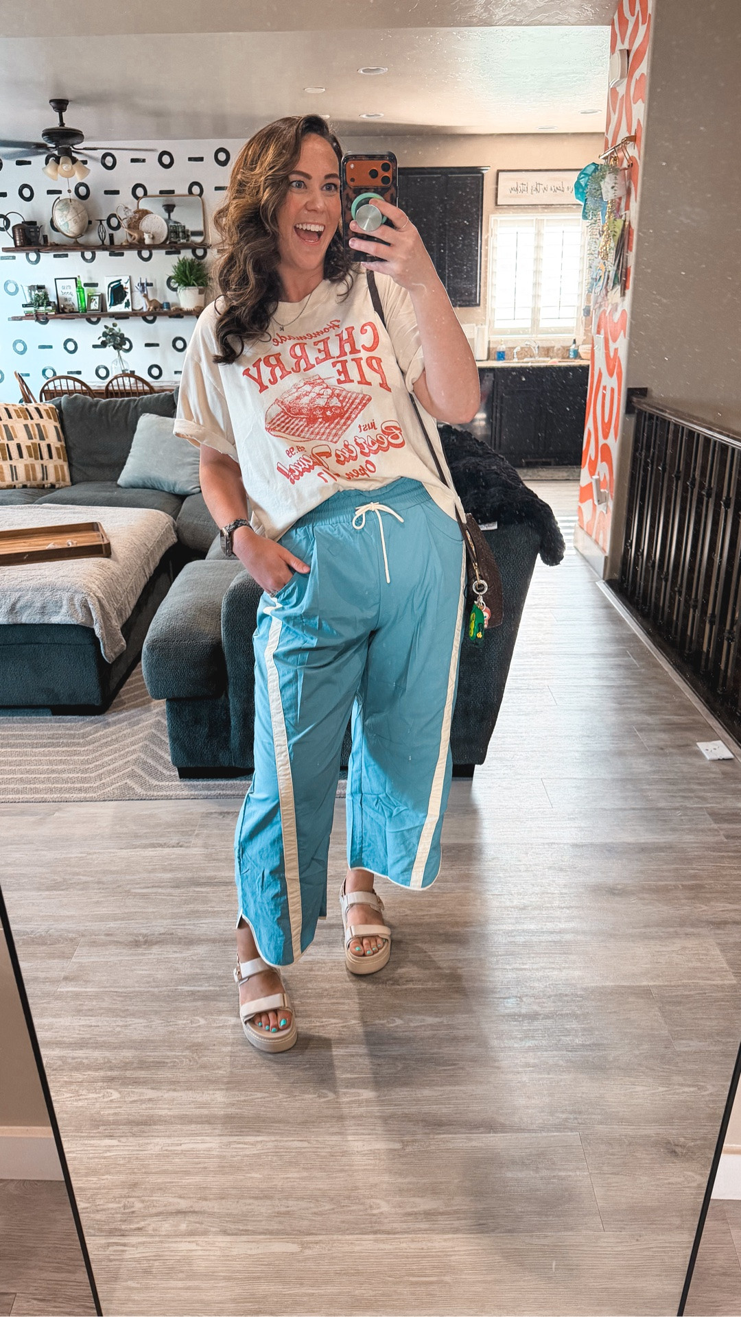Friday energy in these track pants and I am not even a little sorry 😂 This is the “I survived the week” outfit, comfy enough for the couch, cute enough for the office. Swap to sneakers if you need closed-toe!

Bra 38DD 
Undies XL 
Pants XL 
Shirt XL 

casual friday outfit, track pants outfit midsize, graphic tee outfit work, comfy work outfit size 14, end of week outfit, midsize summer outfit, working mom style, blue track pants outfit, oversized tee outfit midsize

#LTKMidsize #LTKTall #LTKWorkwear
