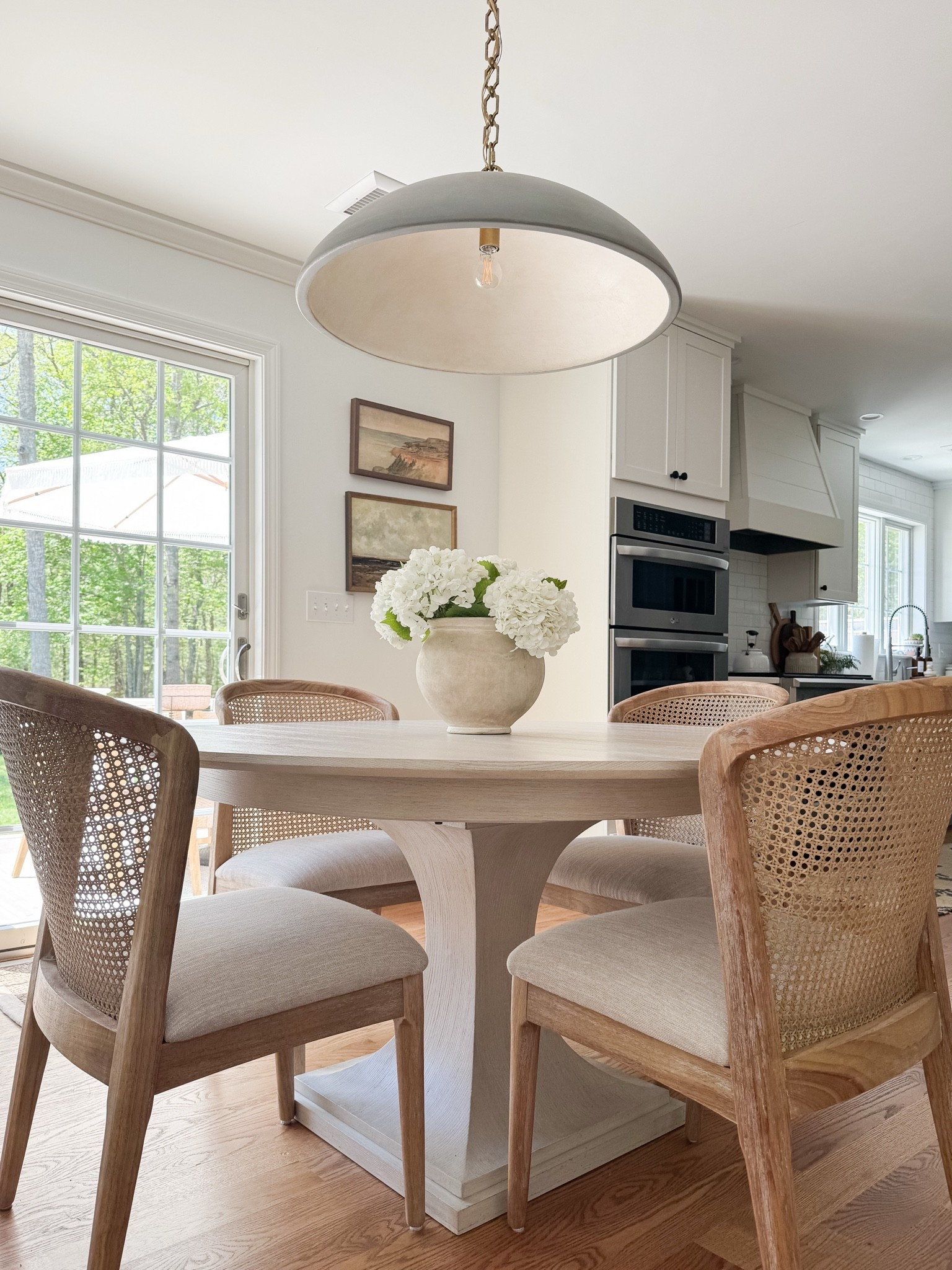 Coastal dining room styled with round wood table, woven dining chairs, faux peony centerpiece, and soft natural light for relaxed coastal dining.

coastal dining room decor, round wood dining table, woven dining chairs, faux peony centerpiece, neutral dining room styling, coastal interior decor, light coastal home, neutral dining room inspiration, sherricalnanhome

#LTKHome