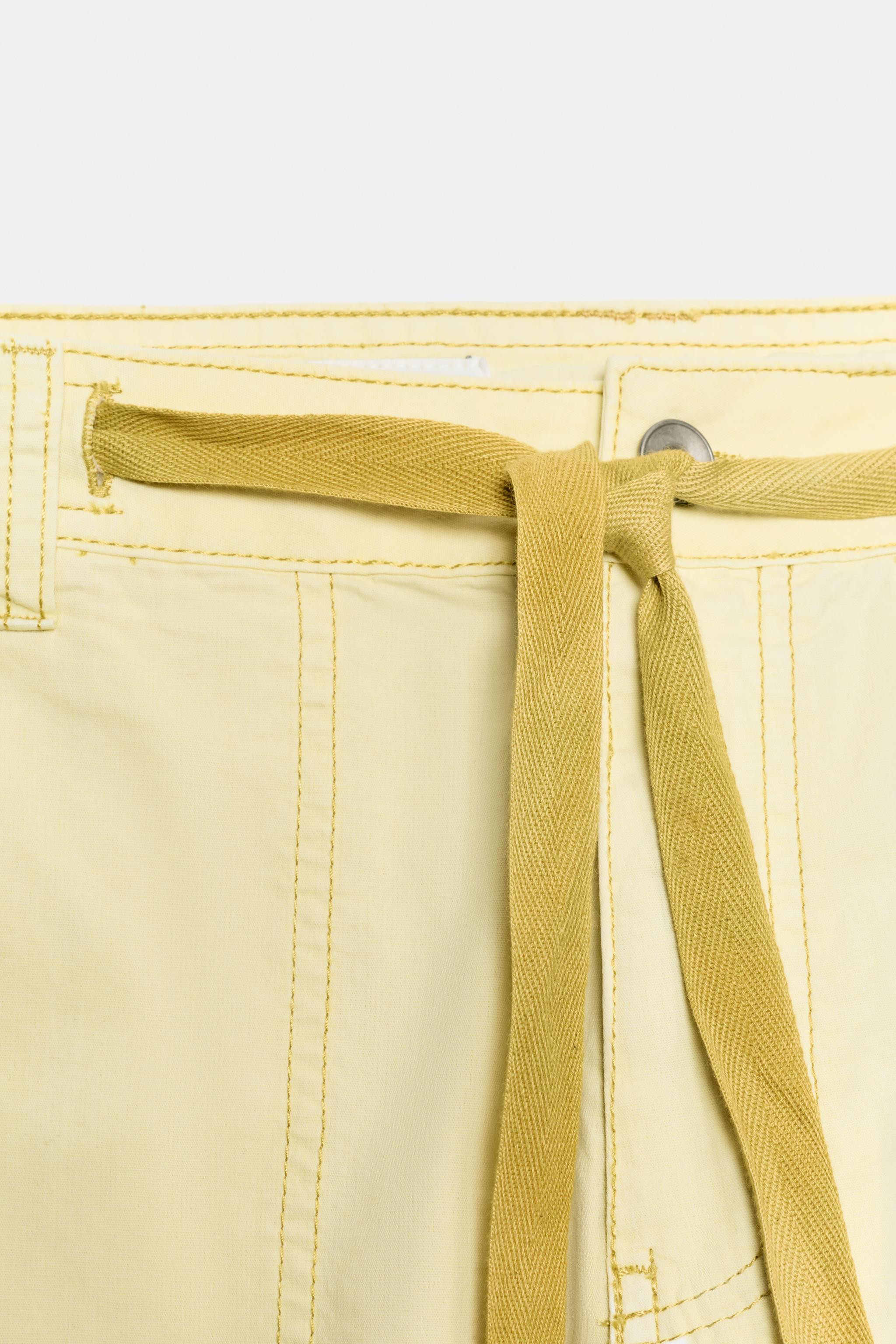 Mid-rise pants with belt loops and adjustable ties. Patch pockets at front, back, and legs. Front... | Zara US