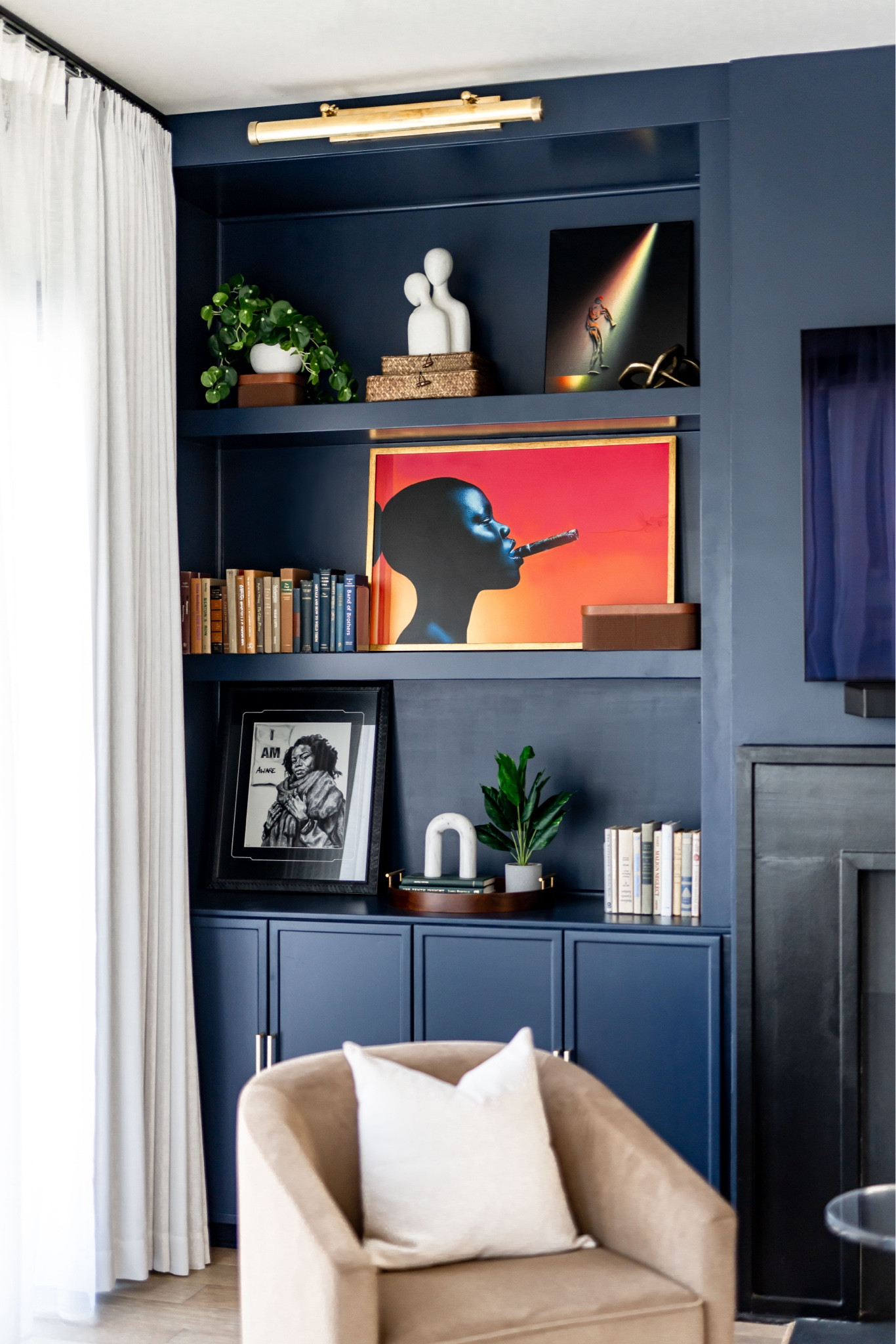 Navy living room with built in bookcases and swivel accent chair 

#LTKHome