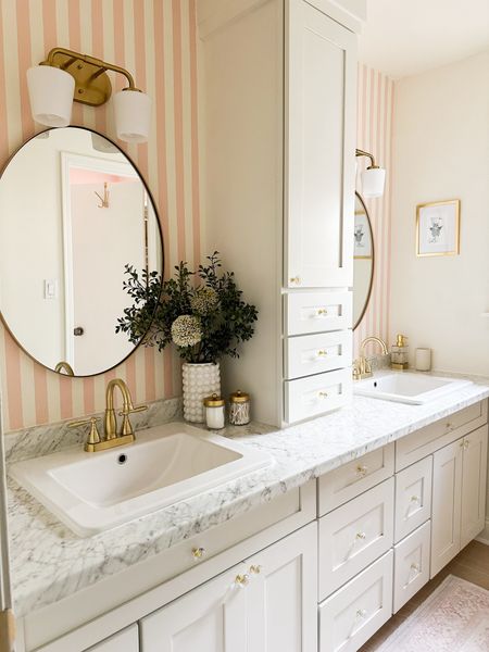 I elevated my girls’ bathroom by incorporating sleek and modern pink stripes and high-quality RTA cabinets. The style of this previously ugly bathroom was completely updated all while optimizing organization. I added the cutest decor and most stylish accessories. #girlsbathroom #diyremodel #pink

#LTKhome