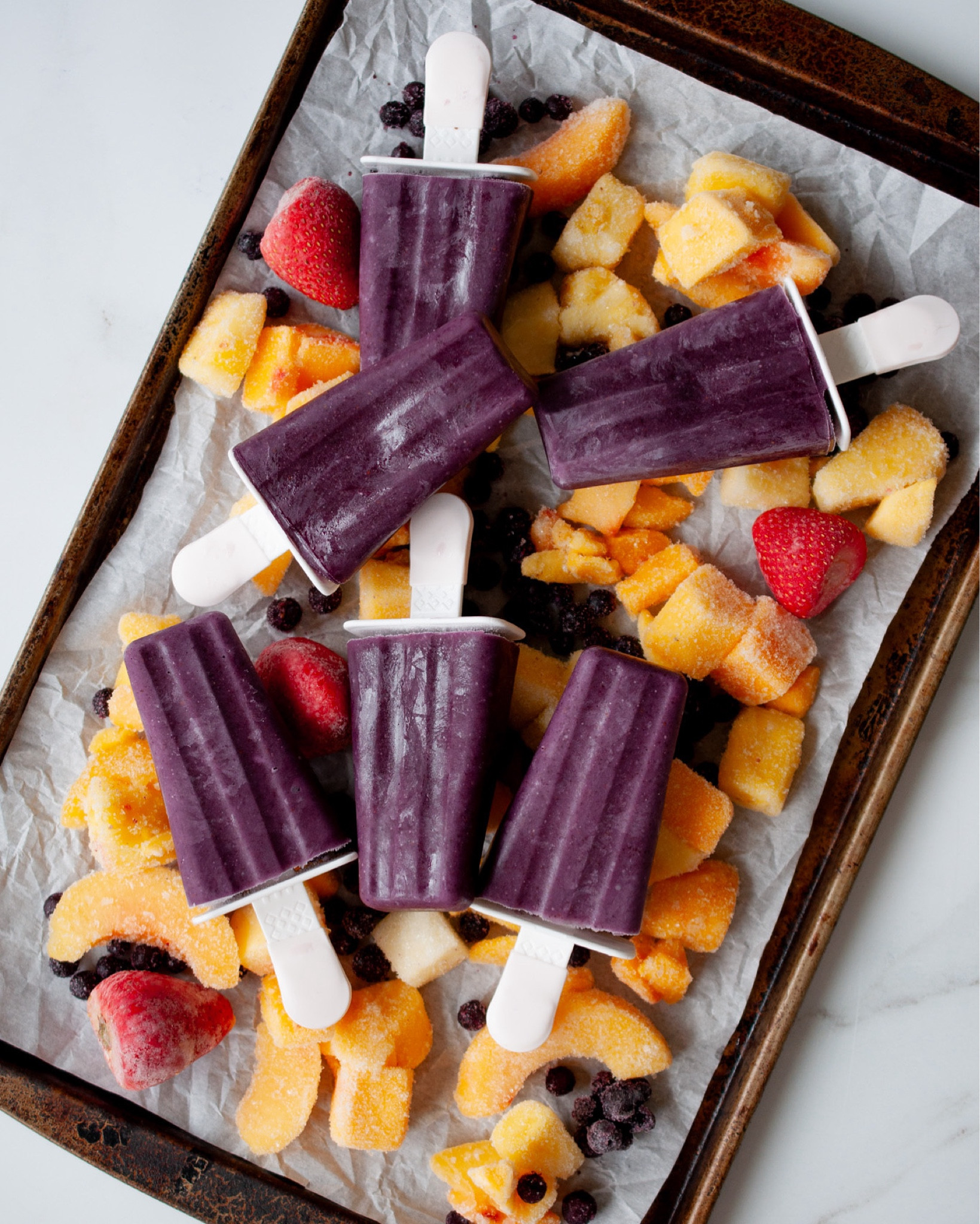 These fruit smoothie popsicles are my kids’ favorite way to eat fruit. They’re an easy, healthy treat whipped up with just 5 ingredients in 5 minutes!

What you’ll need: Makes 10 popsicles
5 oz yogurt cup (I like Oui Coconut Milk Vanilla flavor)
1 1/2 cups frozen fruit of choice
1/2-1 ripe avocado
2 Tbsp raw honey (only add in if kids are age 2+, use agave instead)
1 cup milk of choice (or split 1/2 cup milk + 1/2 cup juice)

Optional additions:
1 tsp blue spirulina
dash of cinnamon
protein powder

How to make it:
Using a blender, combine all of the ingredients until smooth. Pour into popsicle molds and freeze overnight.

Enjoy!