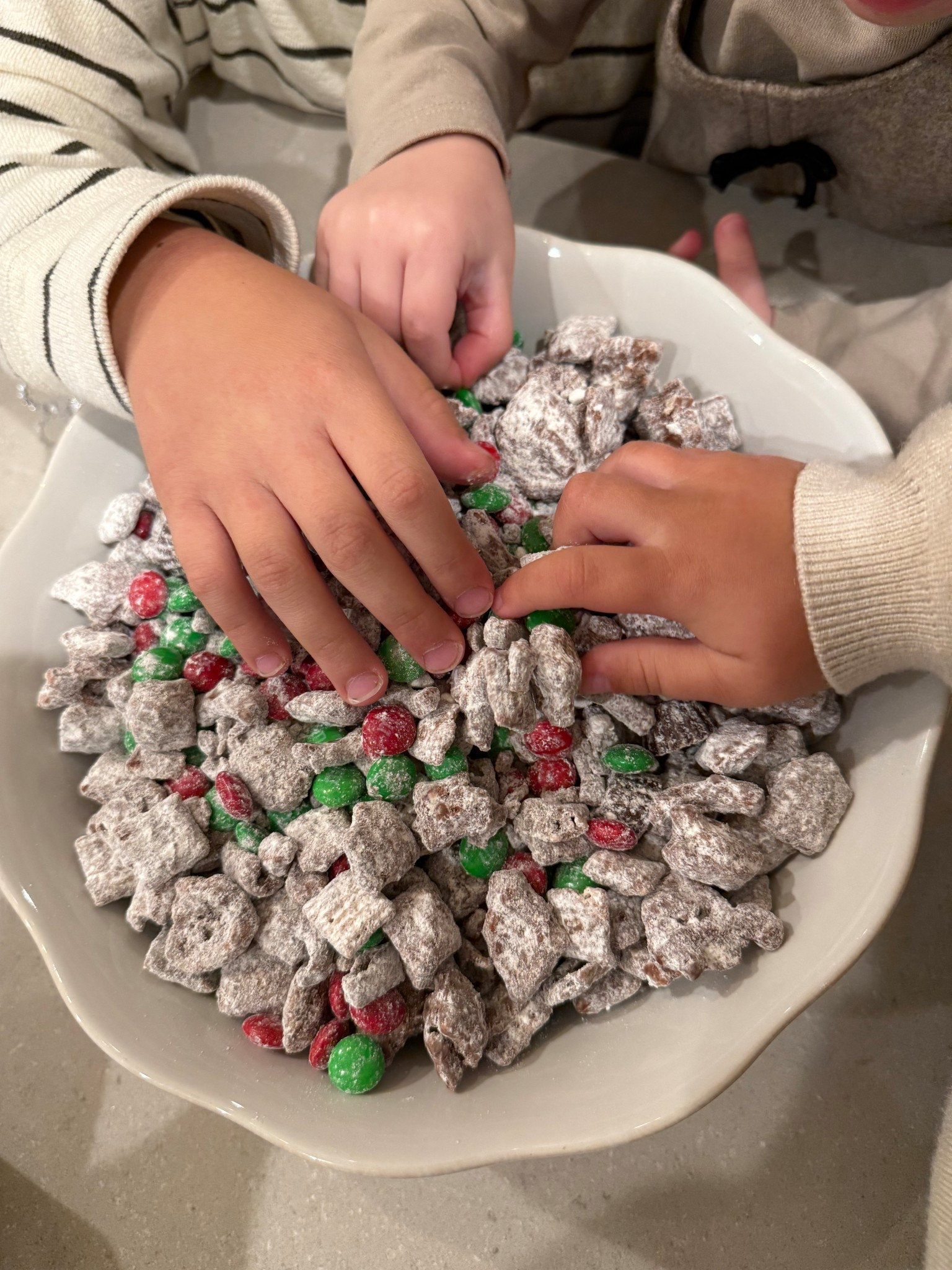 Make Reindeer food with me! My favorite little Christmas treat 🎅🏻🦌 This also makes an easy cute little gift as well 🎁 I linked the containers that you can use for that as well! 
Recipe
• 1 ½ cups semisweet or dark chocolate chips
• 1 ½ cups creamy peanut butter
• 5 cups Rice Chex Cereal
• 1 ½ cups mini pretzels broken into pieces
• 2 cups powdered sugar
• 1 ½ cups red and green M&Ms
• 1 cup mini peanut butter cups

In a large bowl, combine rice Chex cereal and pretzel pieces.
Melt peanut butter and chocolate together, either on the stovetop or in the microwave.
Pour peanut butter chocolate mixture over cereal/pretzel mixture and stir to combine.
Chill in the refrigerator until the mixture just barely begins to set up (about 30 minutes).
Remove the mixture from the refrigerator.
In a separate, large bowl, put ½ cup powdered sugar on the bottom of the bowl. Add half of the chilled mixture, then add another ½ cup powdered sugar over the cereal and the remaining chocolate/cereal mixture.
Gently stir until the powdered sugar is evenly distributed, tossing to coat the cereal with powdered sugar.
Chill the mixture again in the refrigerator until it’s set (about another 30-60 minutes).
Add more powdered sugar, ¼ cup at a time until the cereal/pretzel mixture is coated.
Add M&Ms and peanut butter cups and stir to combine.
Transfer to a serving bowl and serve.

Reindeer food recipe, Christmas treats, Christmas party ideas, Christmas gift ideas, Christmas party favor


#LTKHoliday #LTKSeasonal #LTKfoodie