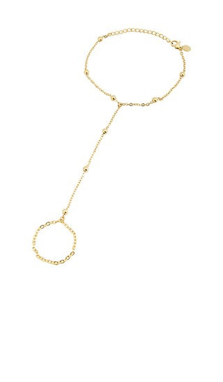 petit moments Sol Hand Chain Bracelet in Metallic Gold. | Revolve Clothing (Global)