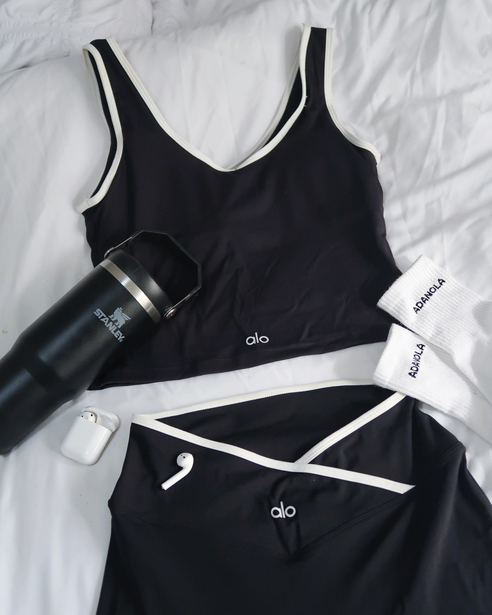 Alo Yoga flared leggings, Alo Yoga longline sports bra, Stanley tumbler, AirPods, Adanola socks, black activewear set, flared leggings outfit, off duty style, everyday uniform, WFH outfits 

#LTKuk #LTKspring #LTKfitness
