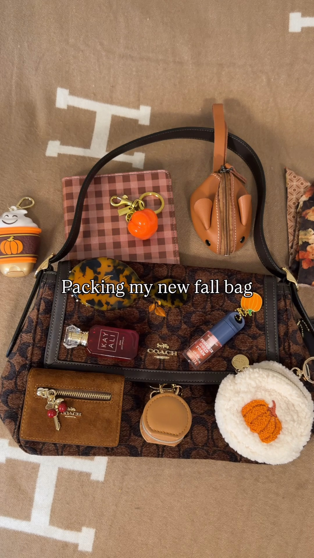 The new large Etta is the perfect bag for fall 🍂 Comment SHOP & I’ll dm you the links 🤎

What’s in my bag:
Coach Outlet chenille large flap Etta 
Fall plaid kindle cover
Leather mouse pouch 
Fall bandaids
Bath and body works Pumpkin spice cold foam lip gloss with pumpkin charm
KayAli Apple mini perfume 
Mini jewelry holding pouch
Coach outlet side wallet with key and cherry charm 
Personalized mini hairbrush from Etsy 
Bath and body works hand sanitizer holder bag charm
Twilly from Amazon
Bear charm from Islander UK 
Pumpkin pouch 
Airbus chain connector
Clear kisslock pouch
Mini rare beauty blush
Mini YSL blush
Mini real techniques beauty blender

#LTKdayinmylife #LTKselfcare #LTKBeauty