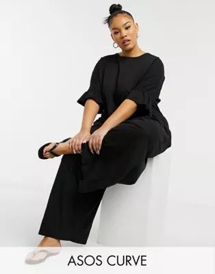 ASOS DESIGN curve jersey smock jumpsuit with ruffle sleeve in black | ASOS (Global)